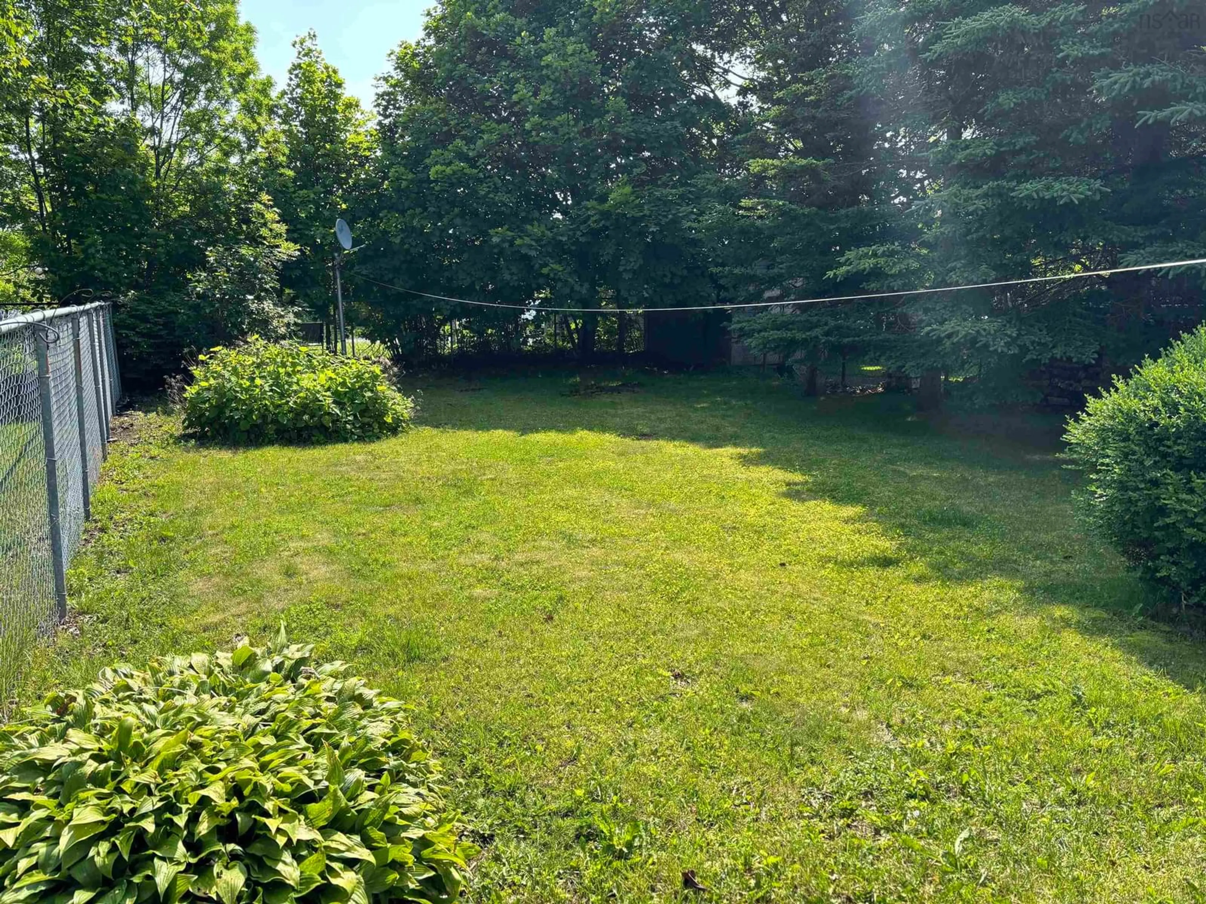 A pic from outside/outdoor area/front of a property/back of a property/a pic from drone, forest/trees view for 19 Clyde Avenue, Sydney Mines Nova Scotia B1V 2E3
