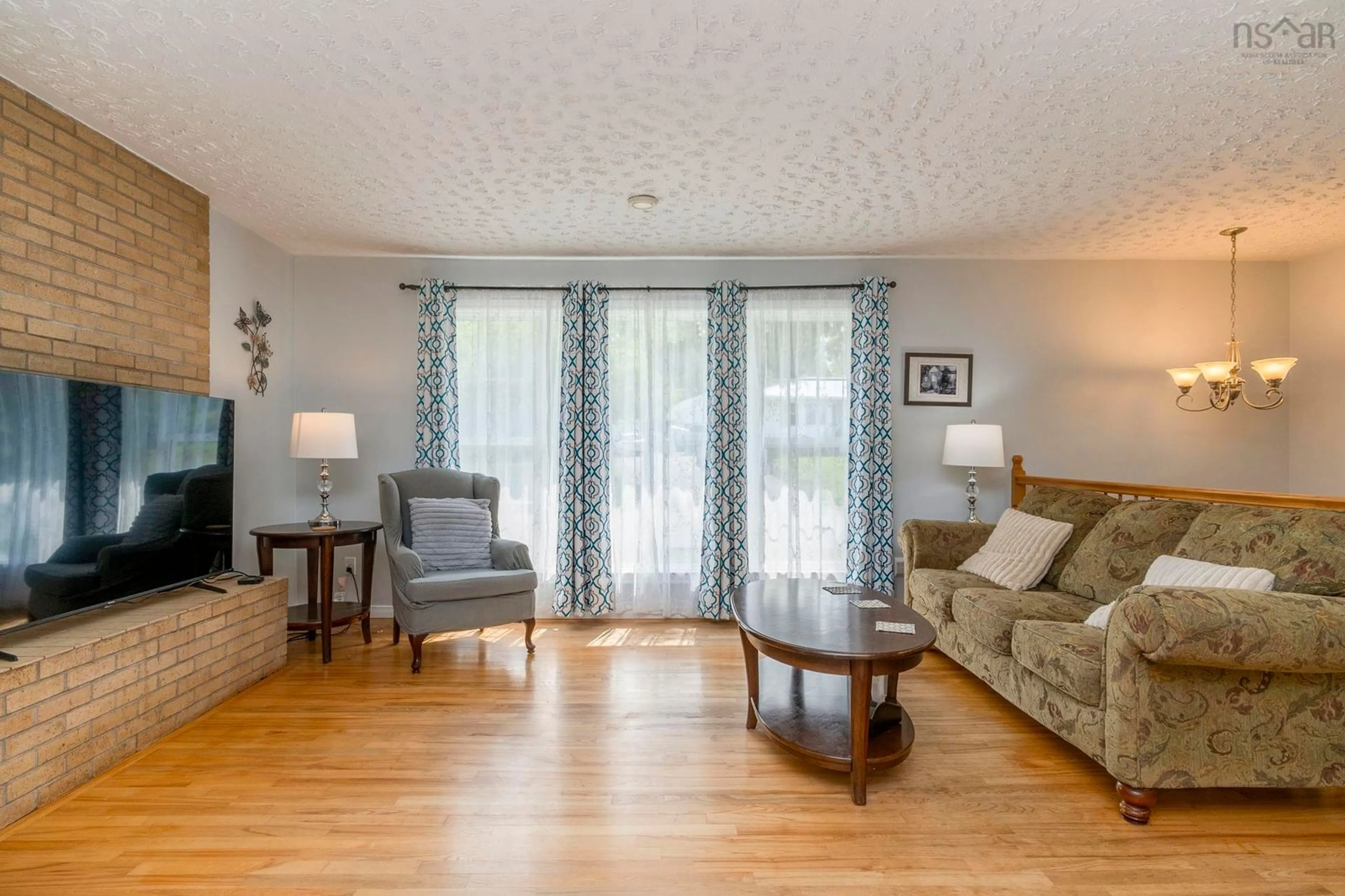 Living room with furniture, wood/laminate floor for 75 Shea St, Lower Sackville Nova Scotia B4C 2B2