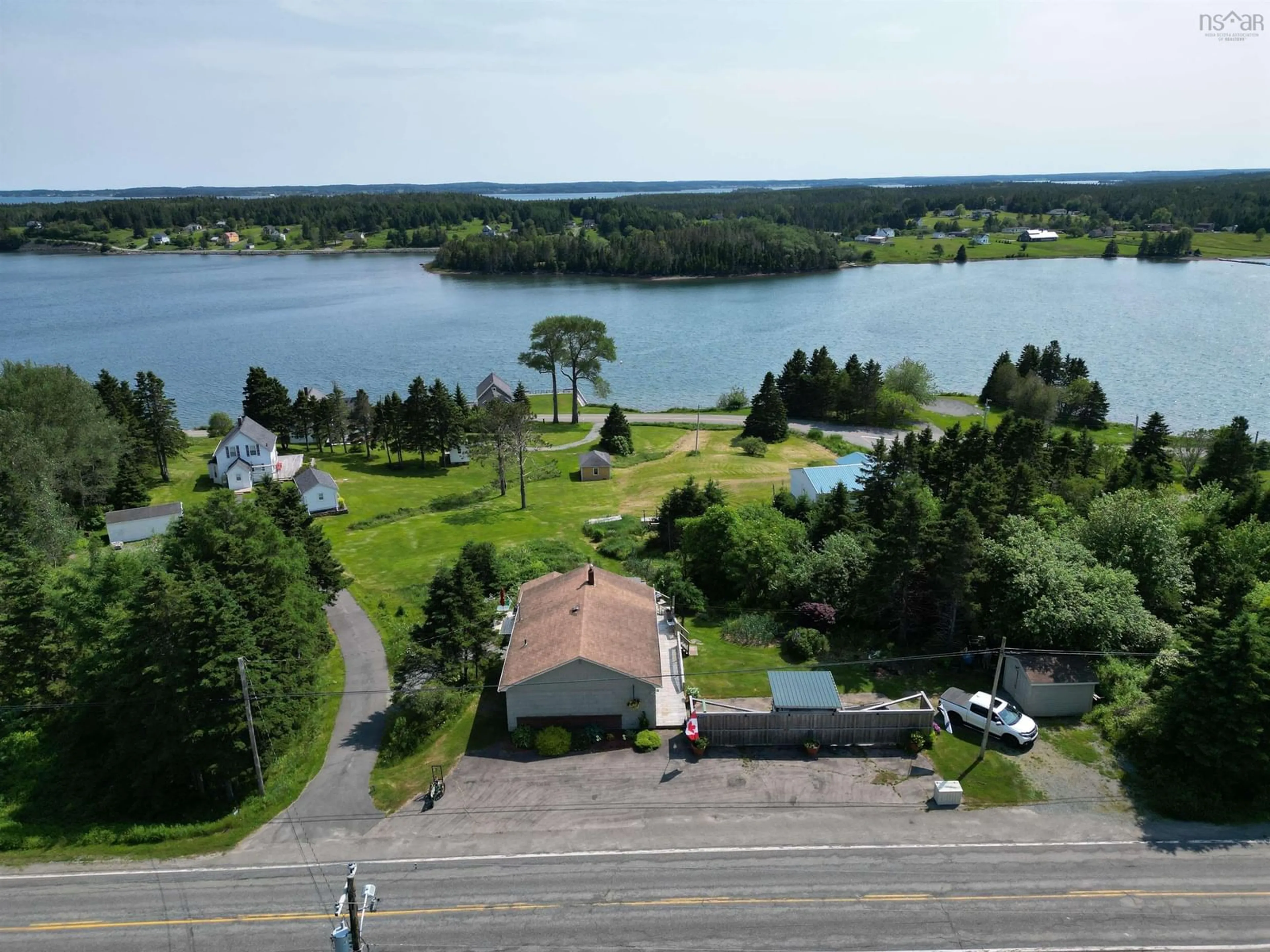 A pic from outside/outdoor area/front of a property/back of a property/a pic from drone, water/lake/river/ocean view for 8316 4 Hwy, River Bourgeois Nova Scotia B0E 2X0