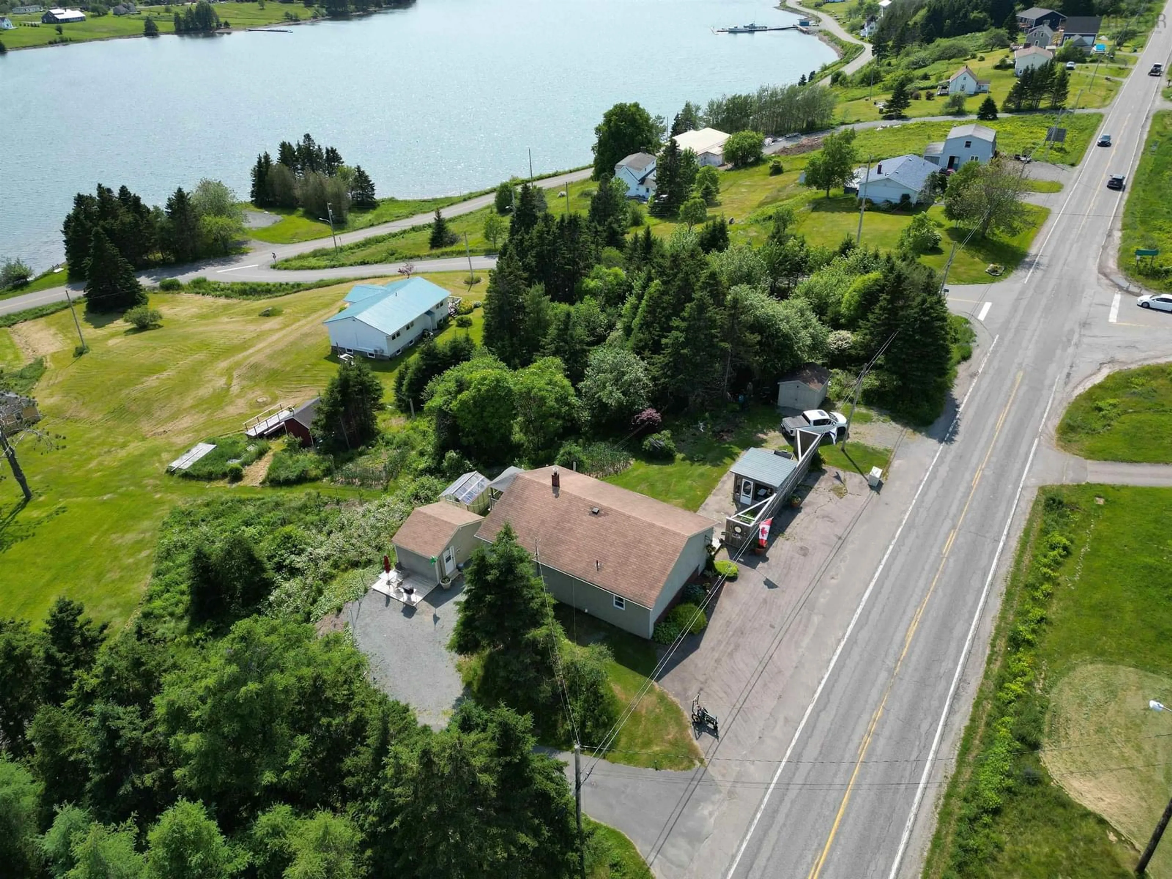 A pic from outside/outdoor area/front of a property/back of a property/a pic from drone, water/lake/river/ocean view for 8316 4 Hwy, River Bourgeois Nova Scotia B0E 2X0