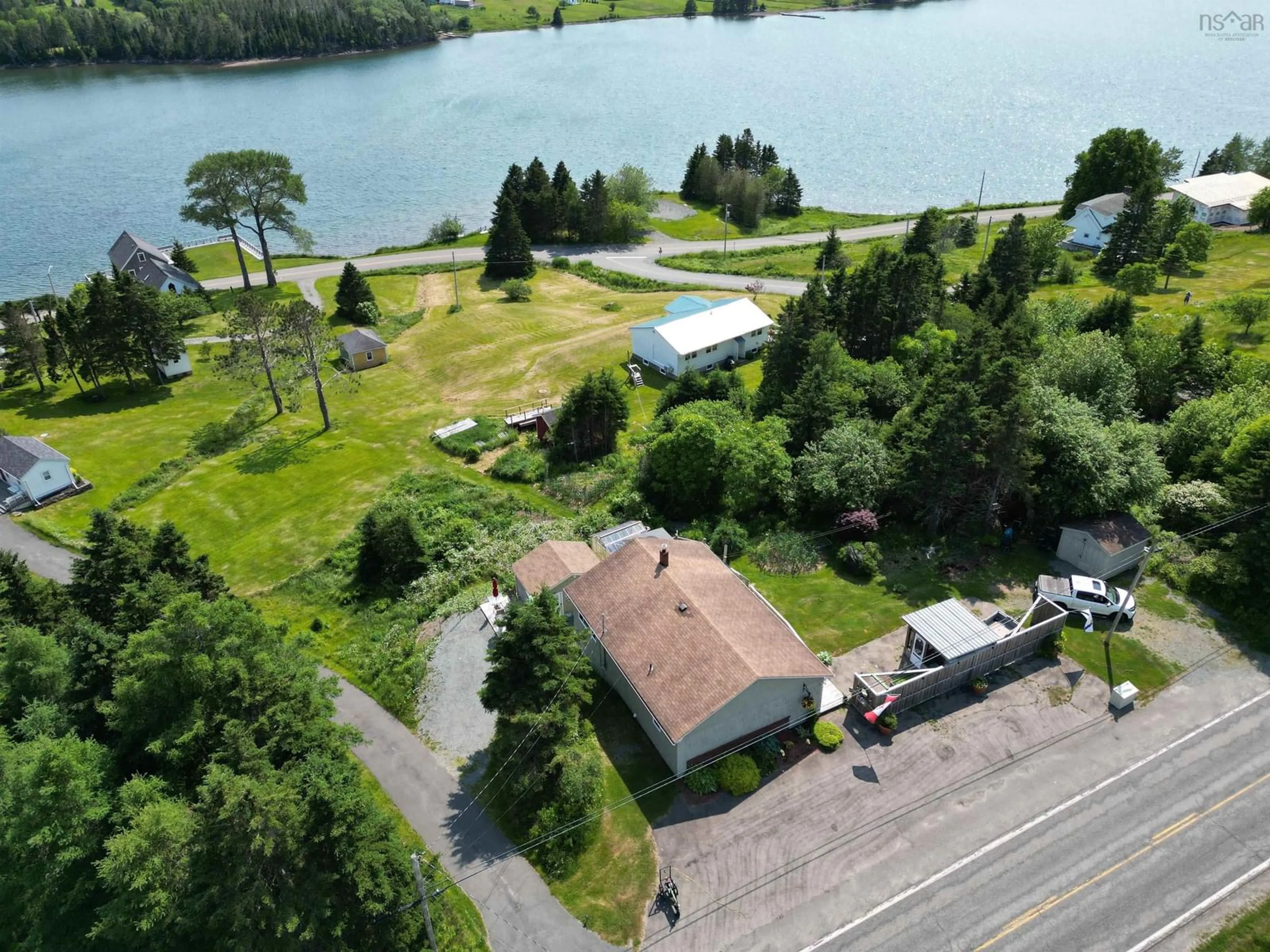 A pic from outside/outdoor area/front of a property/back of a property/a pic from drone, water/lake/river/ocean view for 8316 4 Hwy, River Bourgeois Nova Scotia B0E 2X0