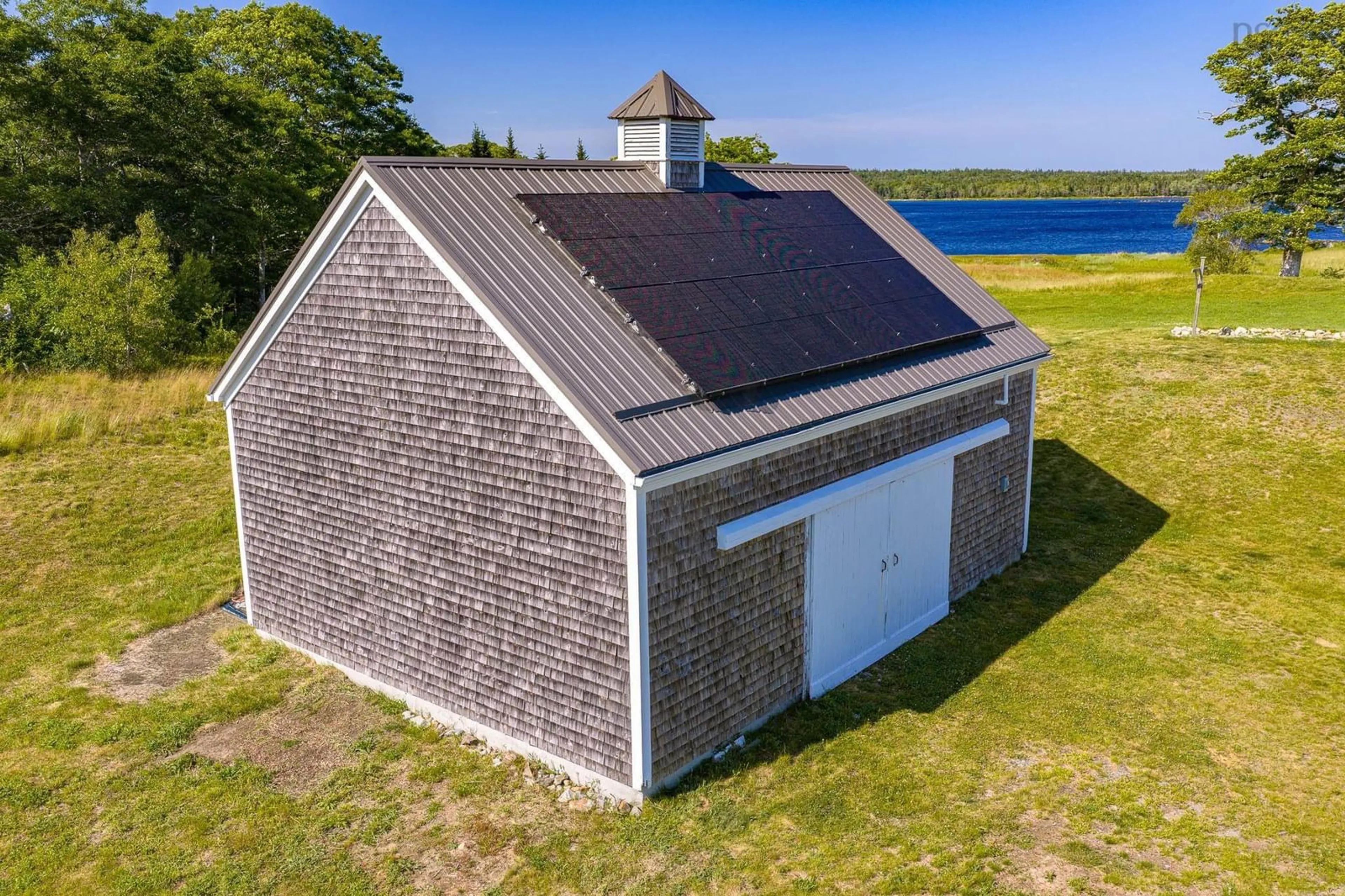 A pic from outside/outdoor area/front of a property/back of a property/a pic from drone, water/lake/river/ocean view for 343 West Sable Rd, Sable River Nova Scotia B0T 1V0