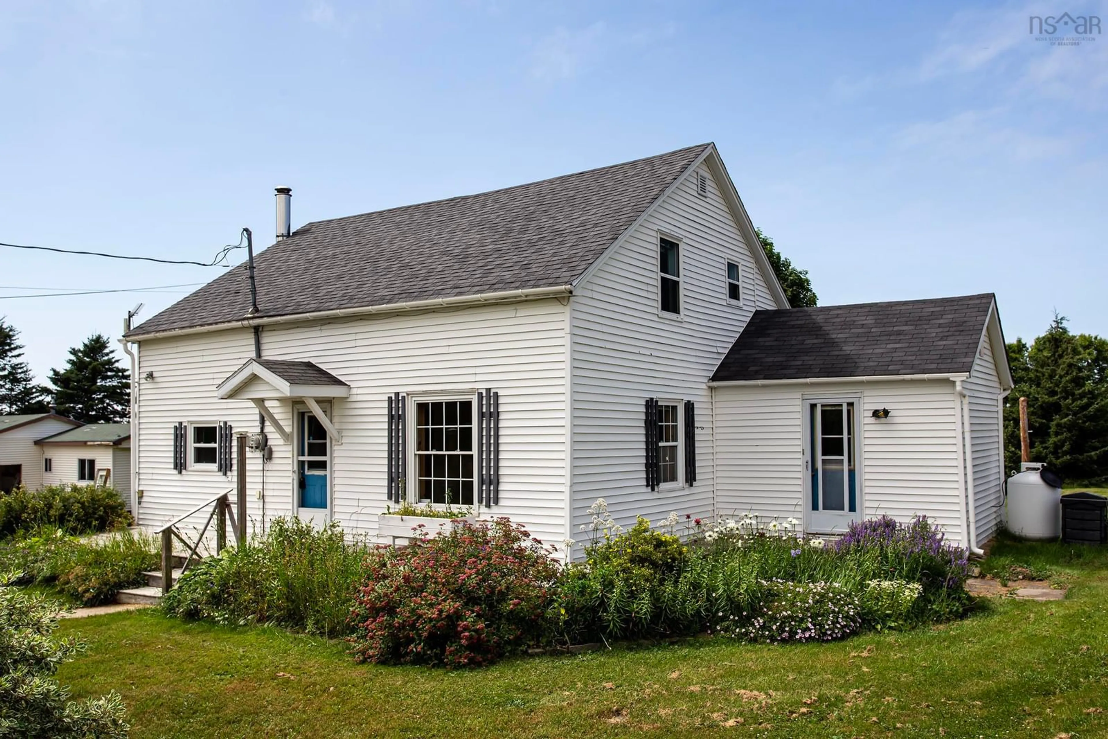 Home with vinyl exterior material, street for 8239 Shore Rd, Hampton Nova Scotia B0S 1L0