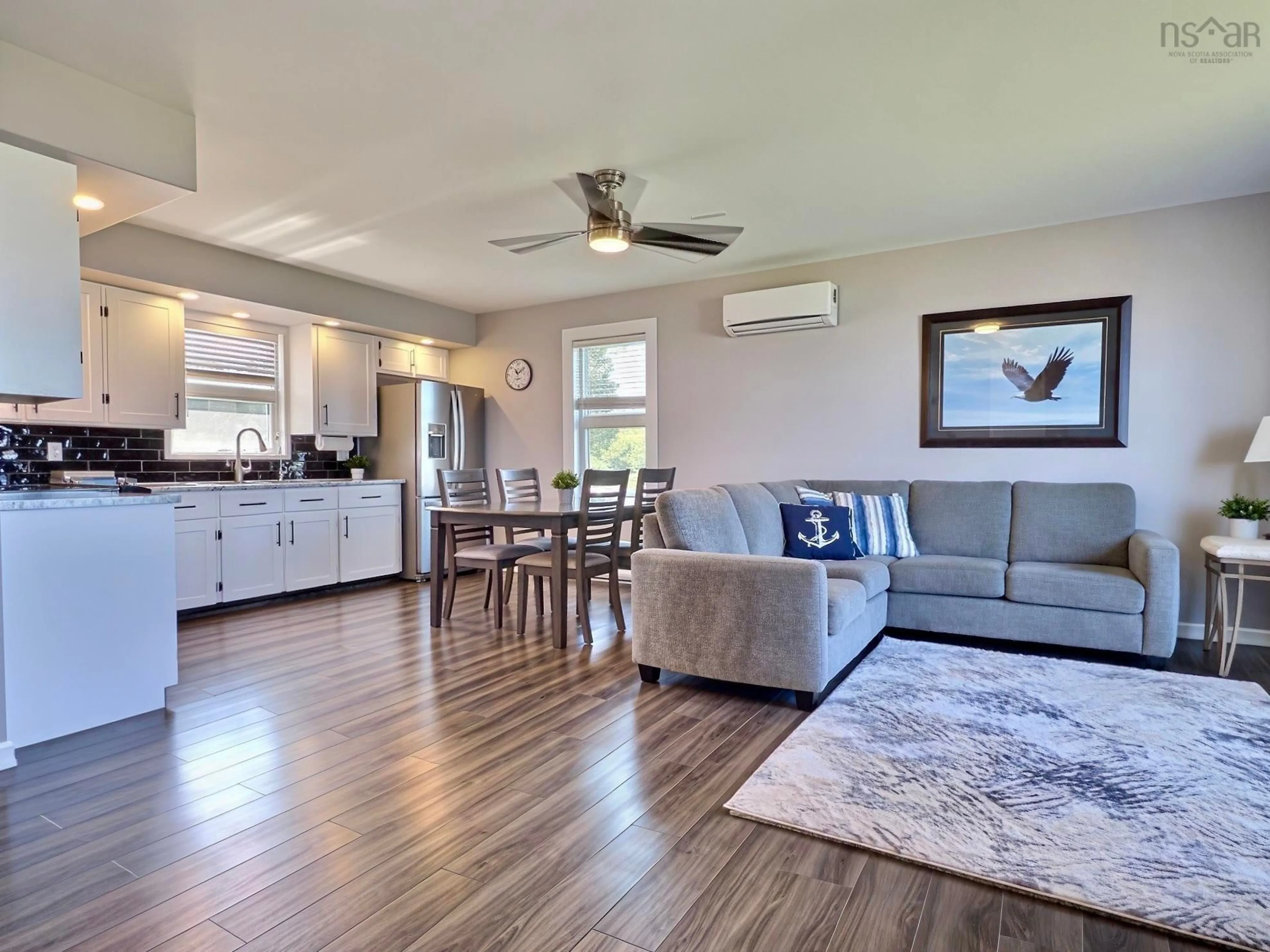 Living room with furniture, wood/laminate floor for 23 Chemin Venette Road, Chéticamp Nova Scotia B0E 1H0