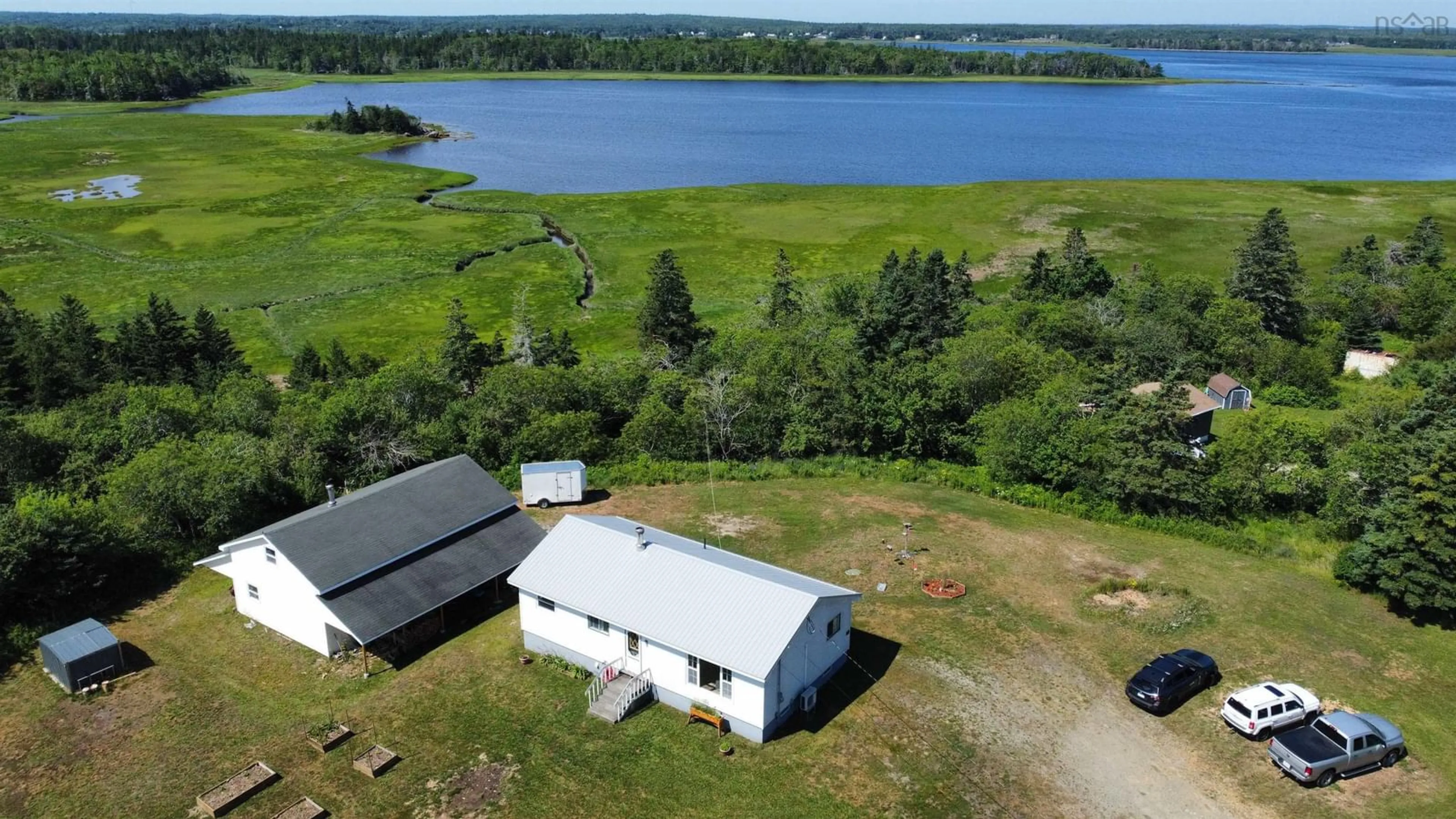A pic from outside/outdoor area/front of a property/back of a property/a pic from drone, water/lake/river/ocean view for 27 Chemin De La Bloquine, Amiraults Hill Nova Scotia B0W 3M0