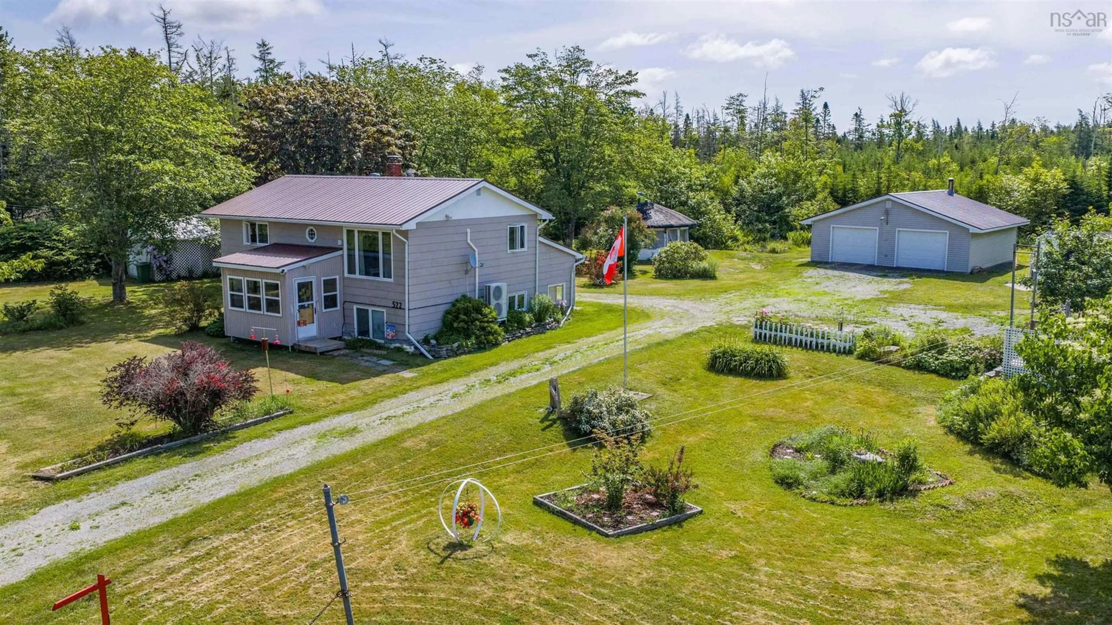 A pic from outside/outdoor area/front of a property/back of a property/a pic from drone, unknown for 522 East River Rd, Sheet Harbour Nova Scotia B0J 3B0