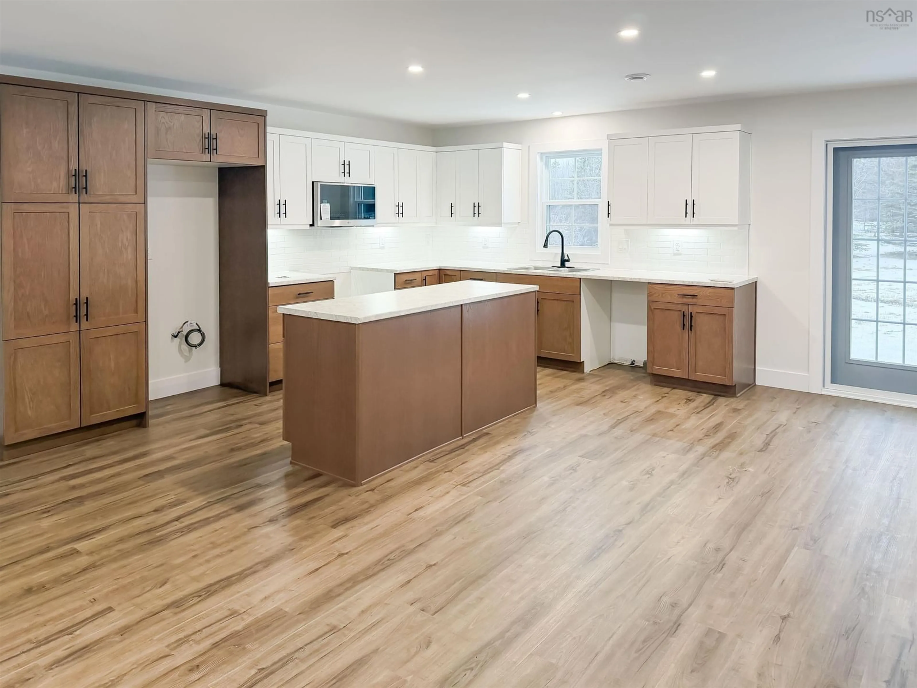 Open concept kitchen, wood/laminate floor for 45 Al Bennett Rd, Halls Harbour Nova Scotia B0P 1J0