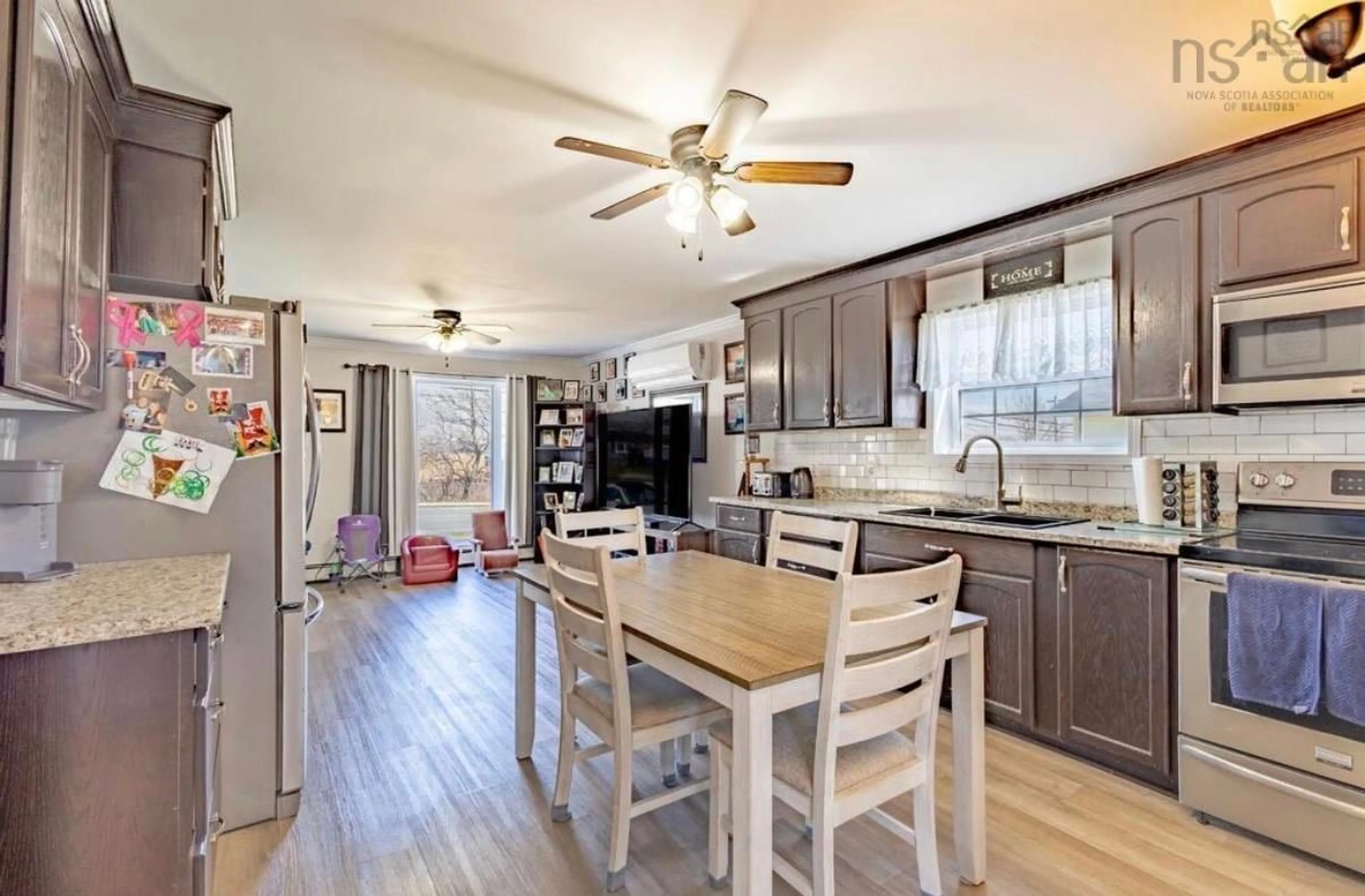 Open concept kitchen, wood/laminate floor for 3752 Ellsworth Ave, New Waterford Nova Scotia B1H 2H8