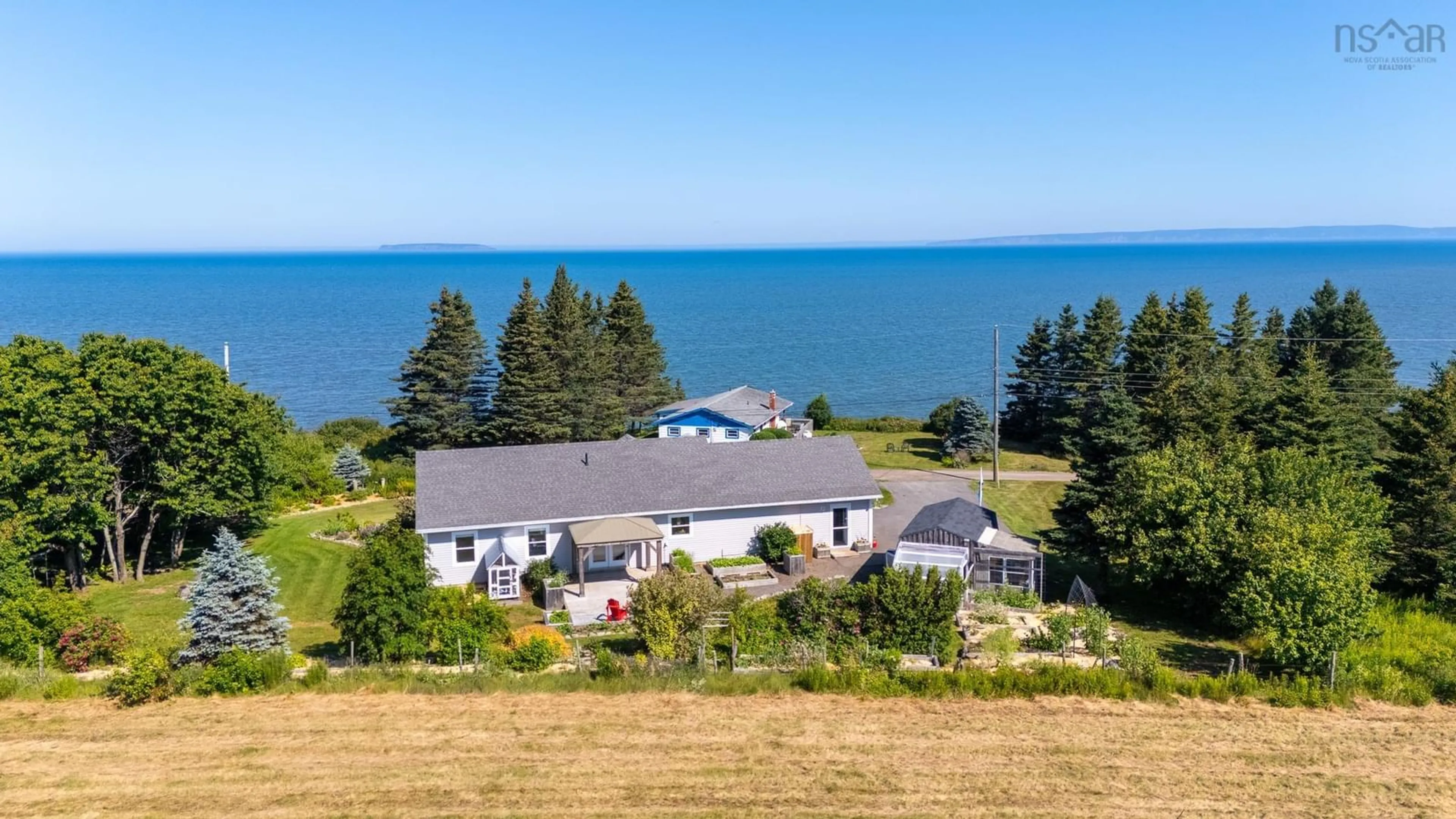 A pic from outside/outdoor area/front of a property/back of a property/a pic from drone, water/lake/river/ocean view for 162 Cottage Rd, Ogilvie Nova Scotia B0P 1E0