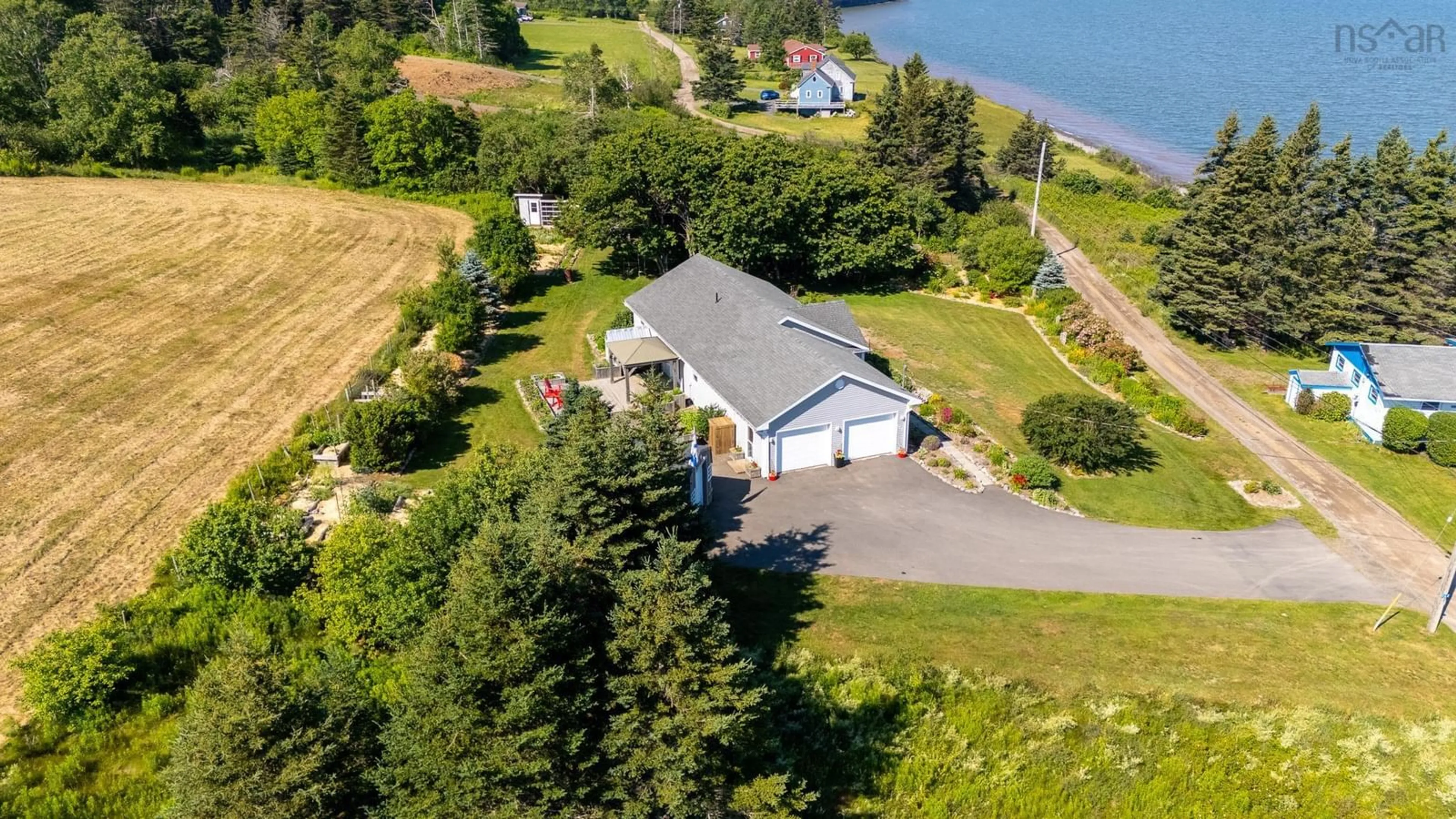 A pic from outside/outdoor area/front of a property/back of a property/a pic from drone, water/lake/river/ocean view for 162 Cottage Rd, Ogilvie Nova Scotia B0P 1E0