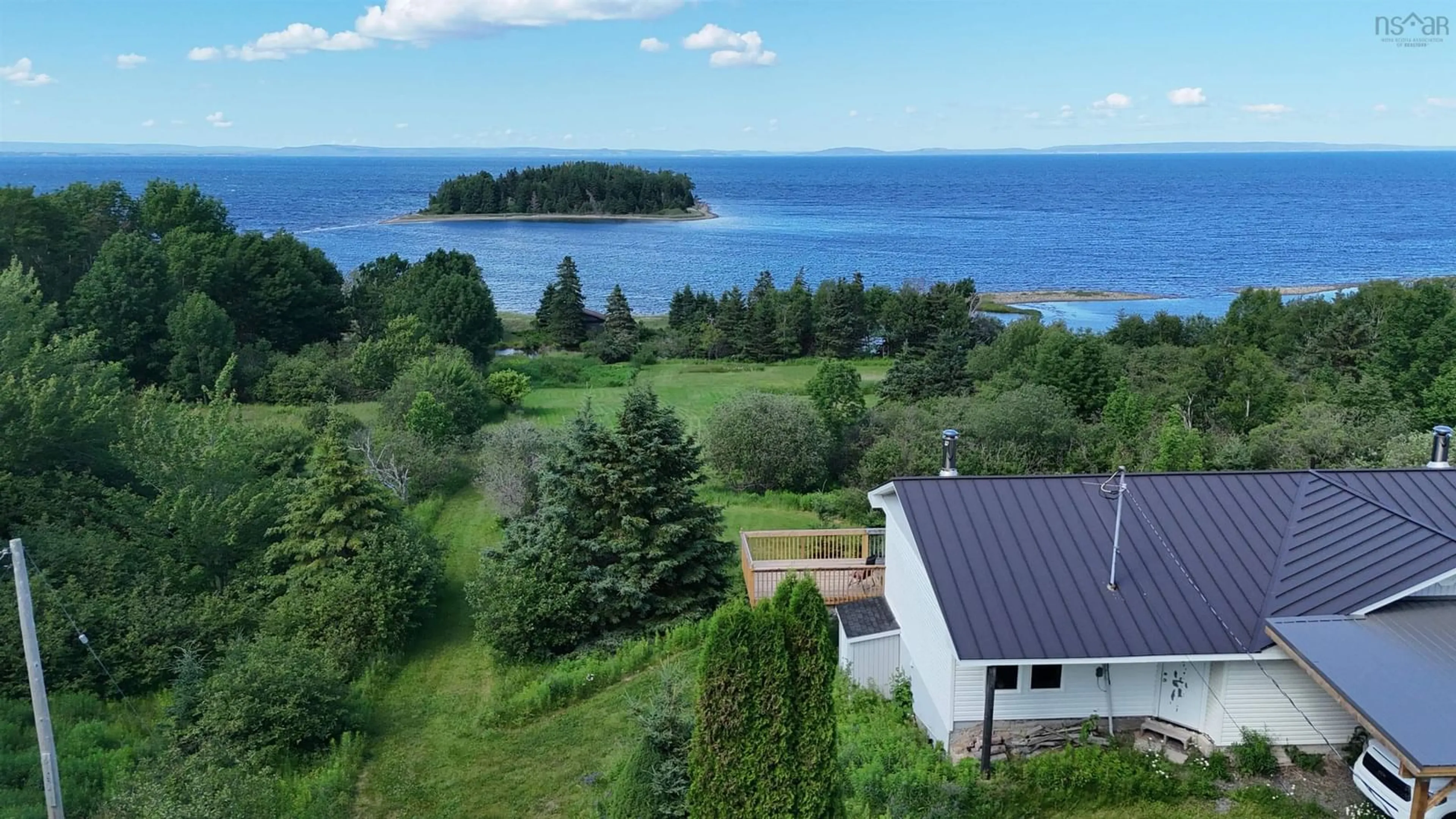 A pic from outside/outdoor area/front of a property/back of a property/a pic from drone, water/lake/river/ocean view for 5877 West Bay Rd, Roberta Nova Scotia B0E 3K0