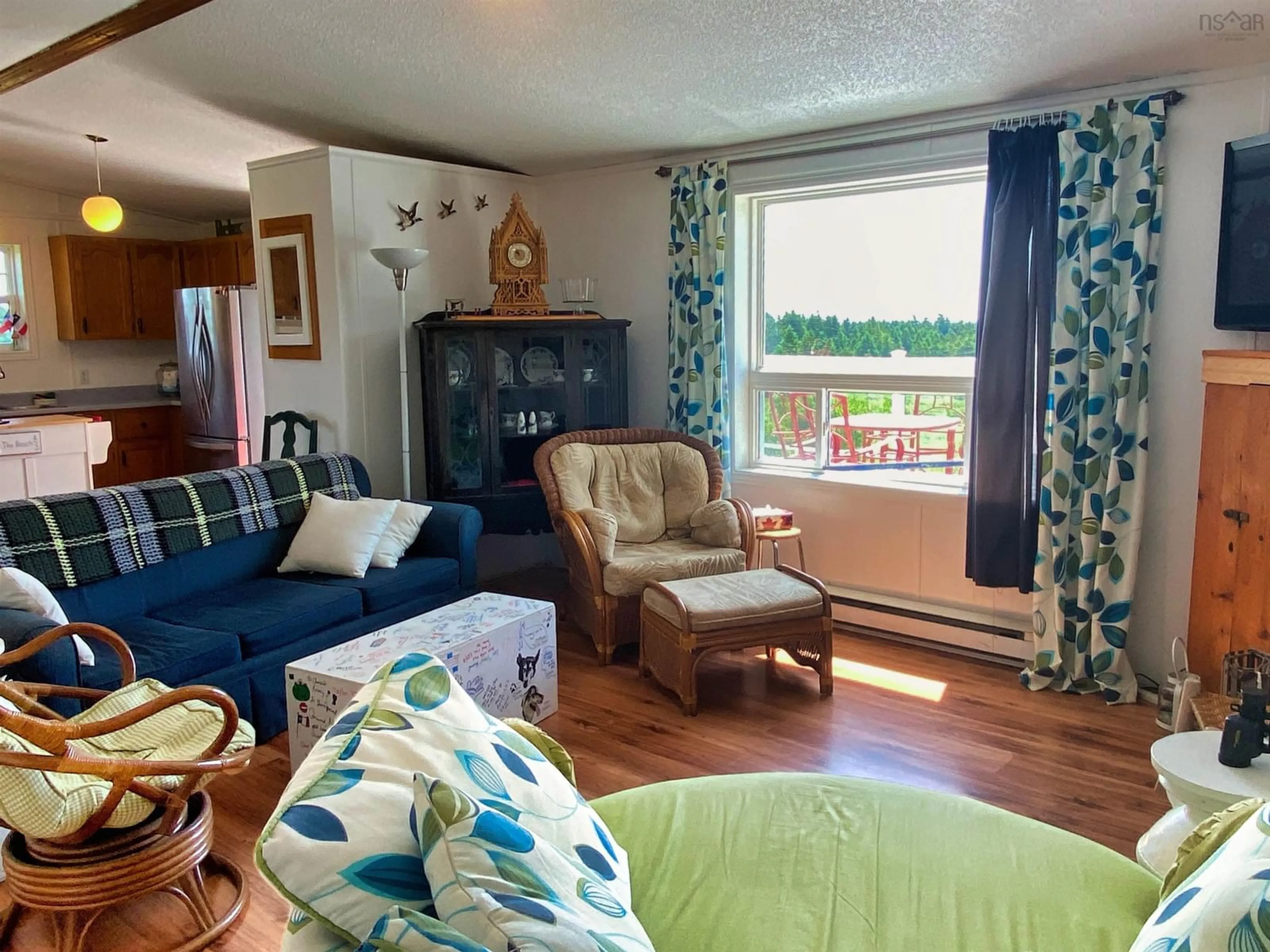 Living room with furniture, wood/laminate floor for 23 Evong Rd, L'Ardoise Nova Scotia B0E 3B0