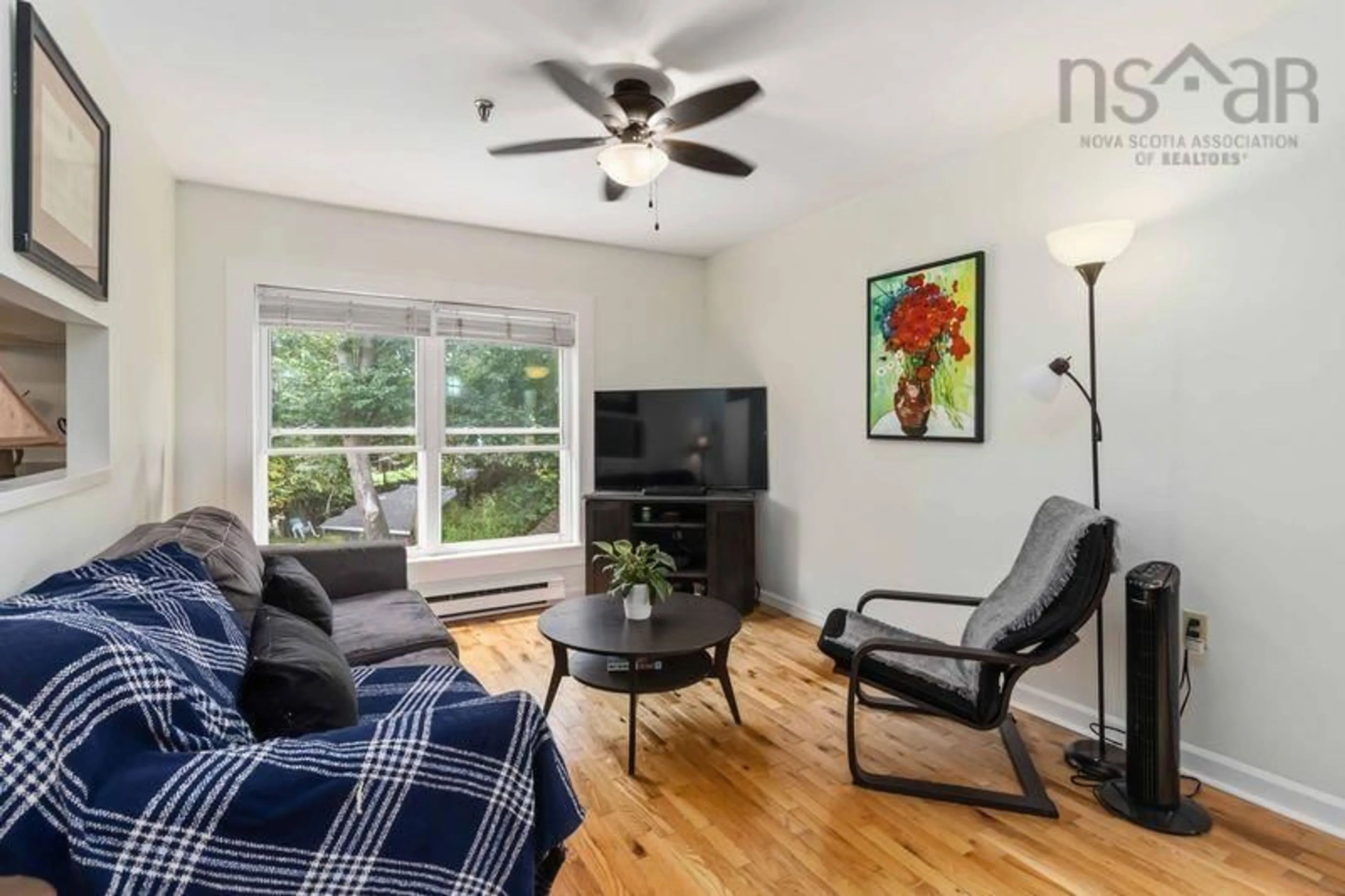 Living room with furniture, wood/laminate floor for 5444 Victoria Rd #12, Halifax Peninsula Nova Scotia B3H 1M5