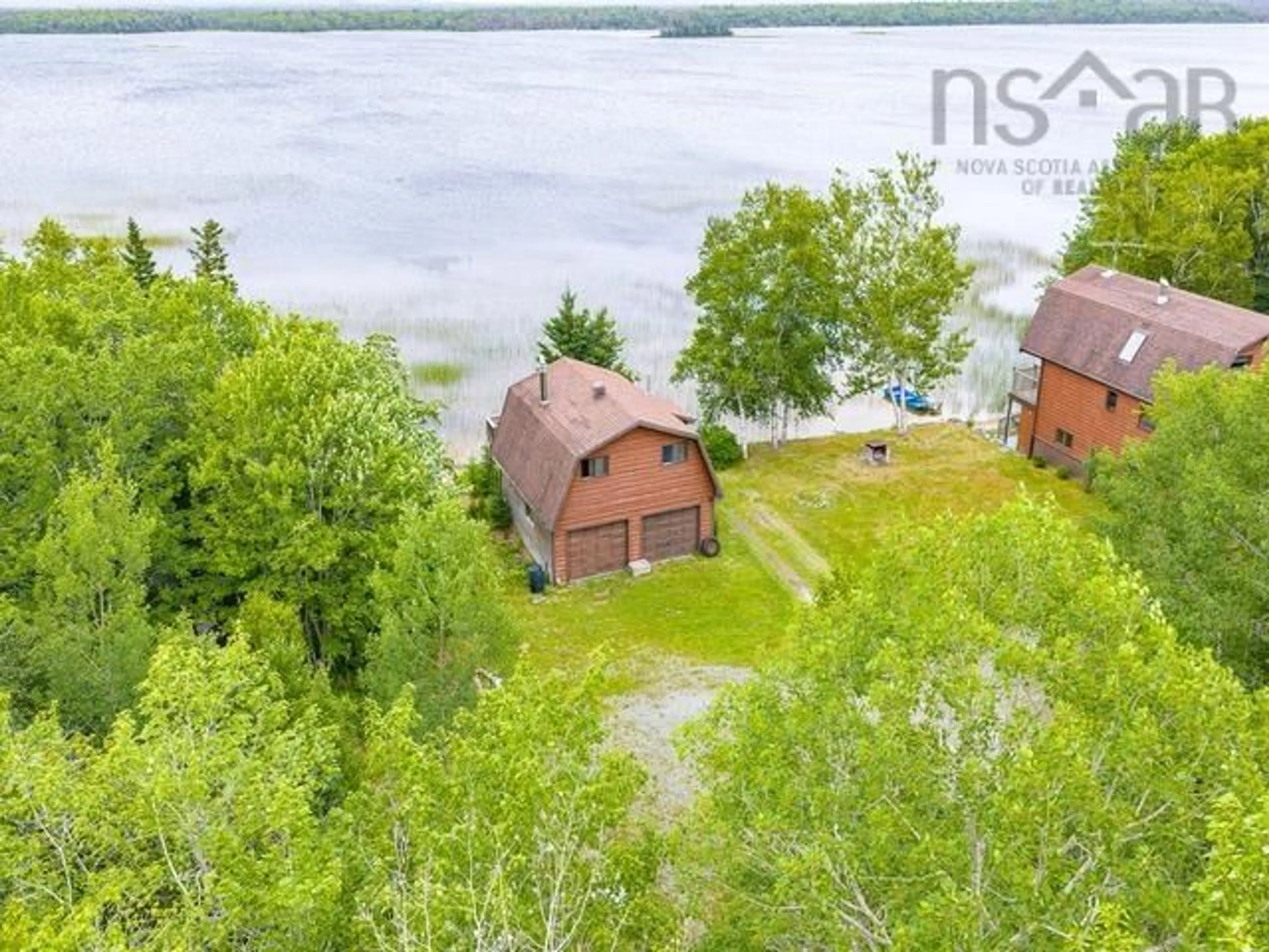 A pic from outside/outdoor area/front of a property/back of a property/a pic from drone, water/lake/river/ocean view for 233 Greenwodd Lake Road, Port Saxon Nova Scotia B0W 2S0