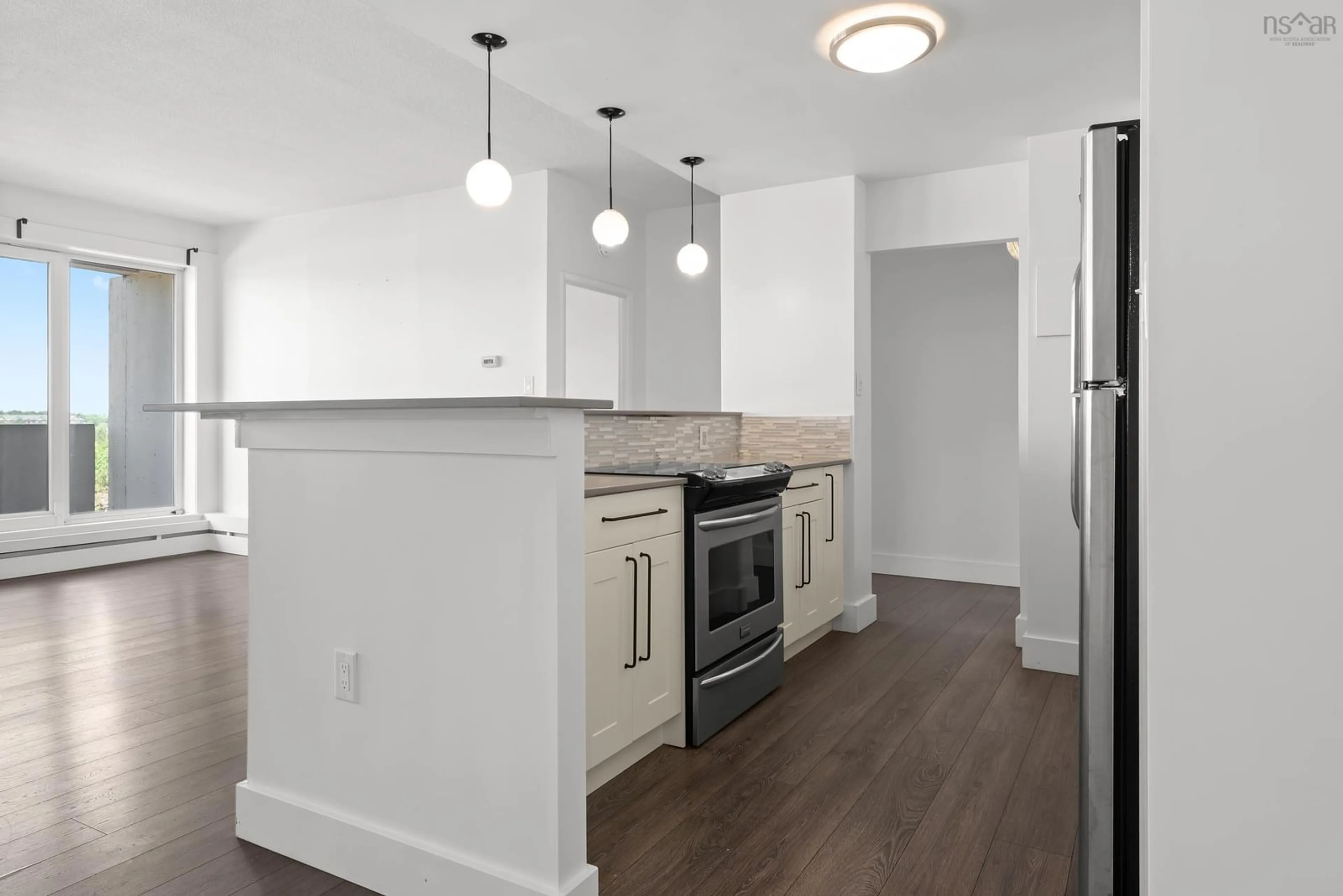 Open concept kitchen, wood/laminate floor for 105 Dunbrack St #808, Halifax Nova Scotia B3M 3G7