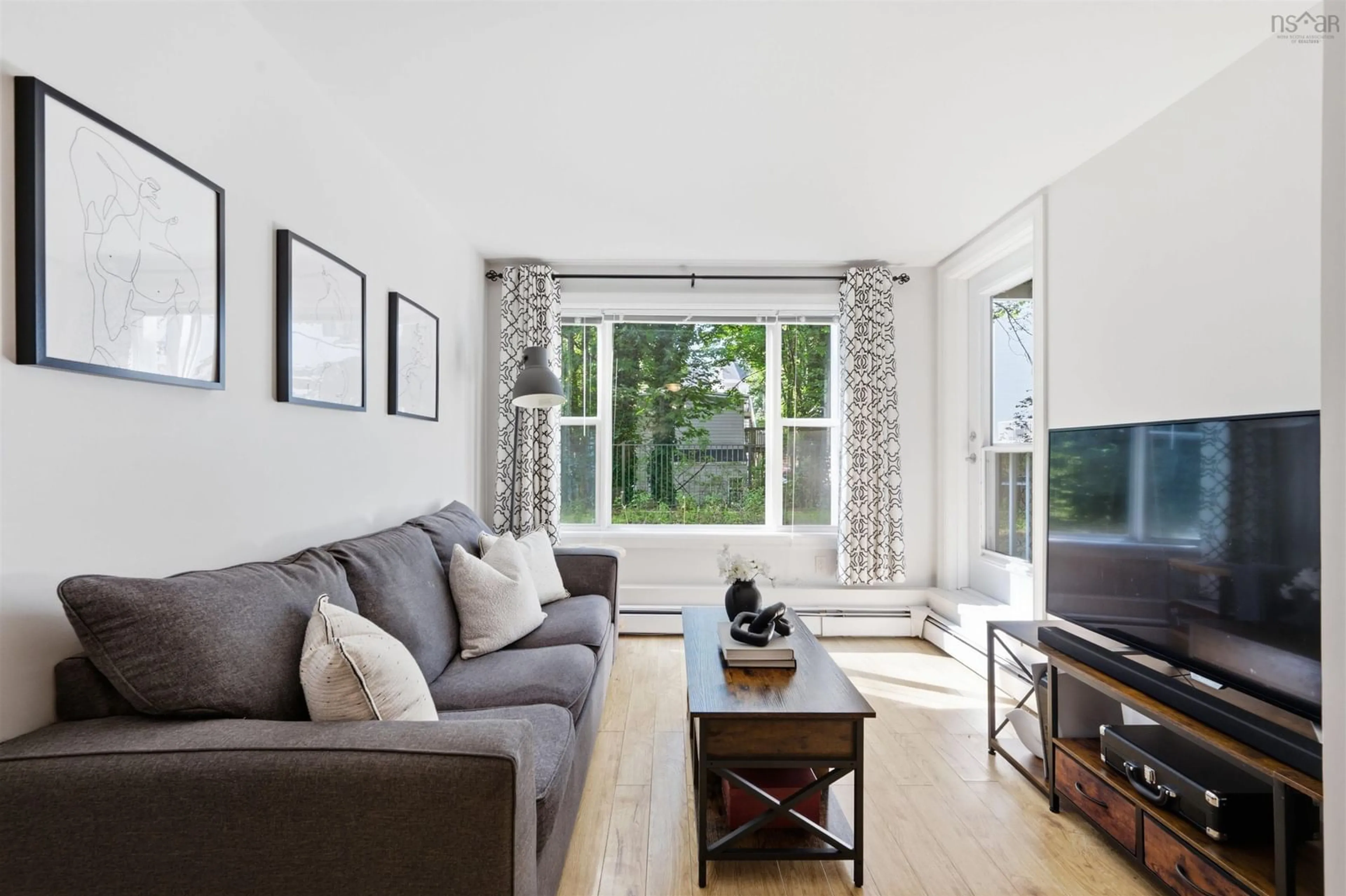 Living room with furniture, wood/laminate floor for 5230 Tobin St #105, Halifax Nova Scotia B3H 1S2