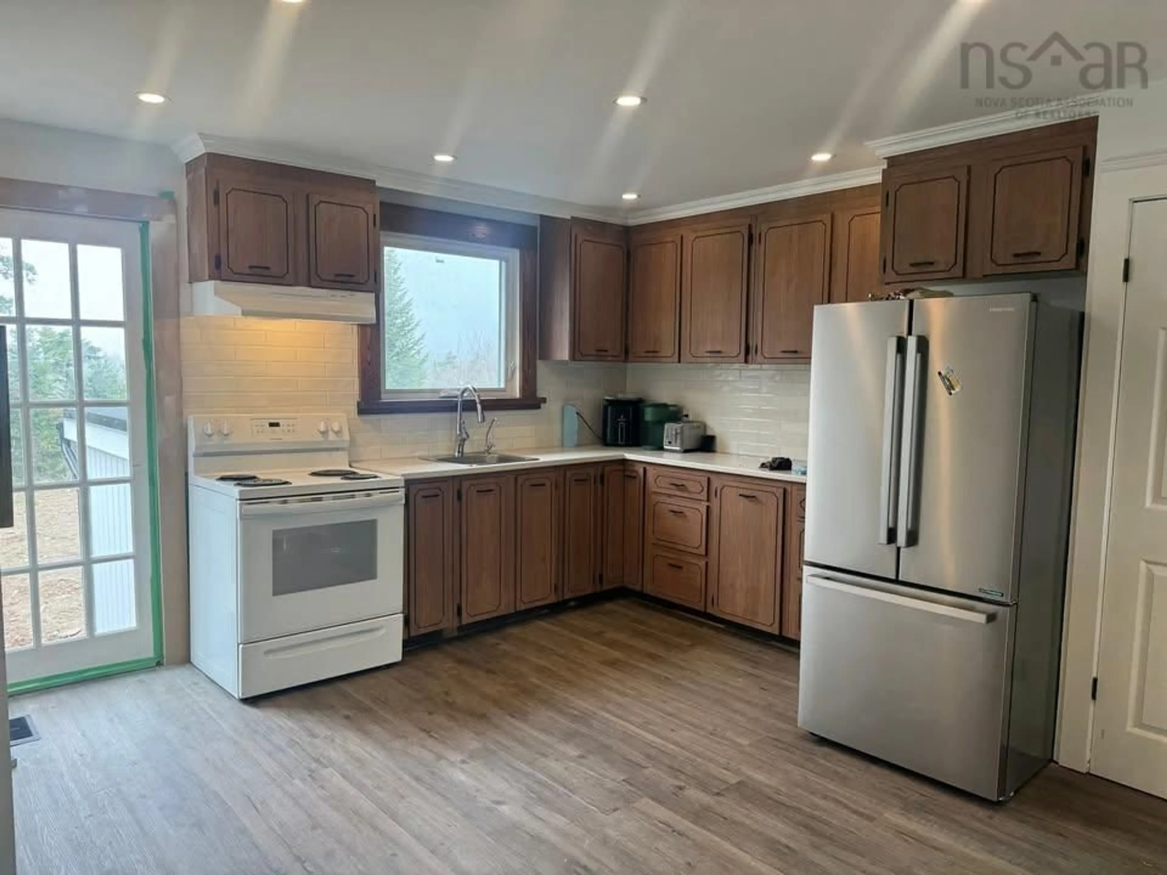 Open concept kitchen, wood/laminate floor for 3804 Lawrencetown Rd, Lawrencetown Nova Scotia B2Z 1P9