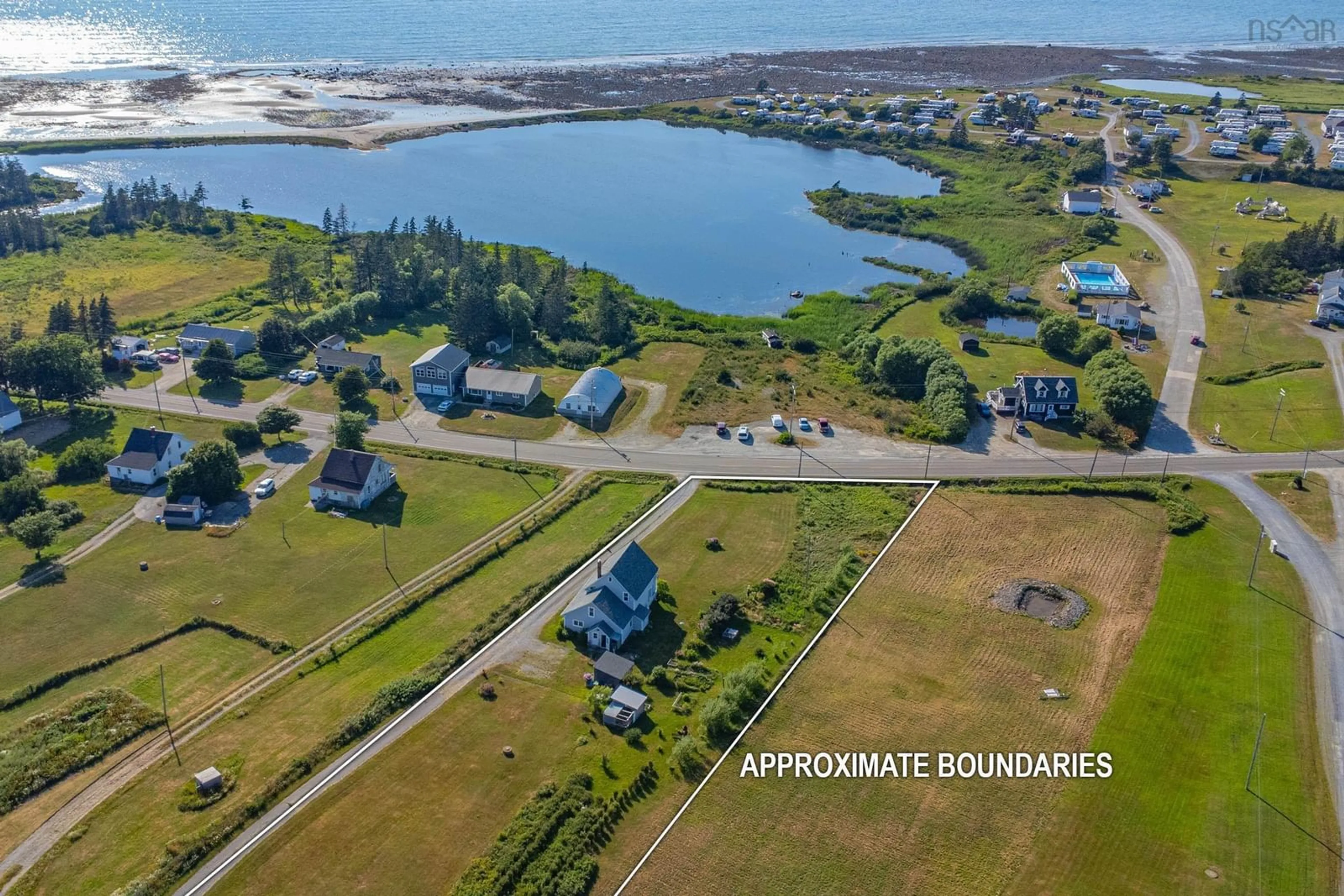 A pic from outside/outdoor area/front of a property/back of a property/a pic from drone, water/lake/river/ocean view for 2118 Highway 1, Grosses Coques Nova Scotia B0W 1M0