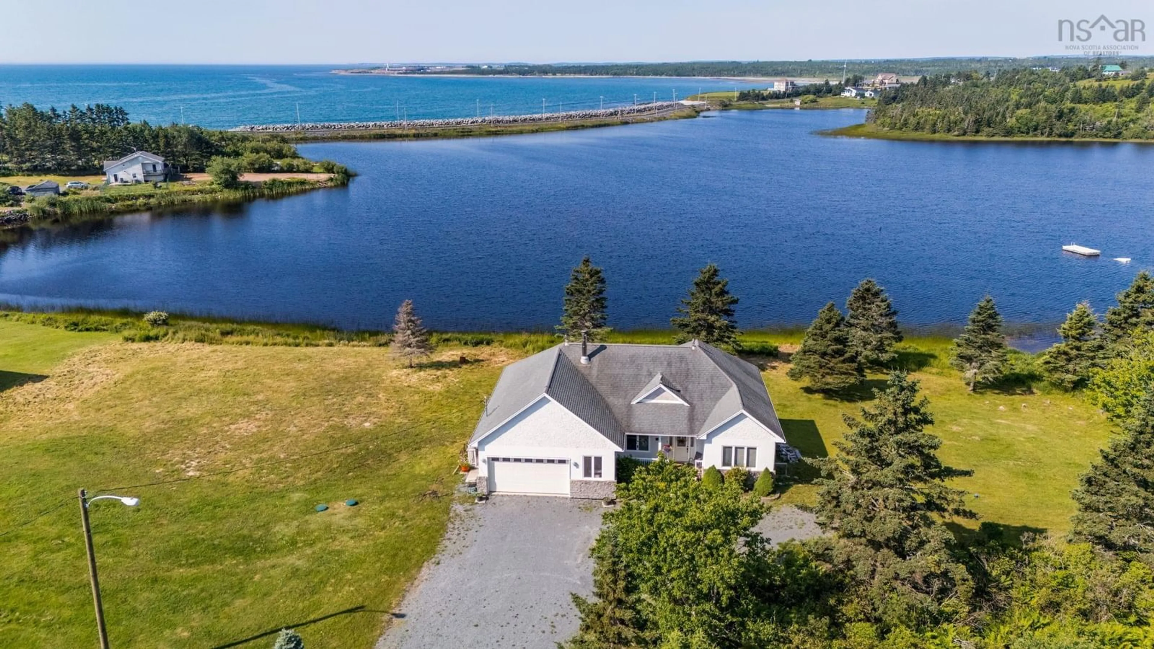 A pic from outside/outdoor area/front of a property/back of a property/a pic from drone, water/lake/river/ocean view for 1480 Cow Bay Road, Cow Bay Nova Scotia B3G 1L3