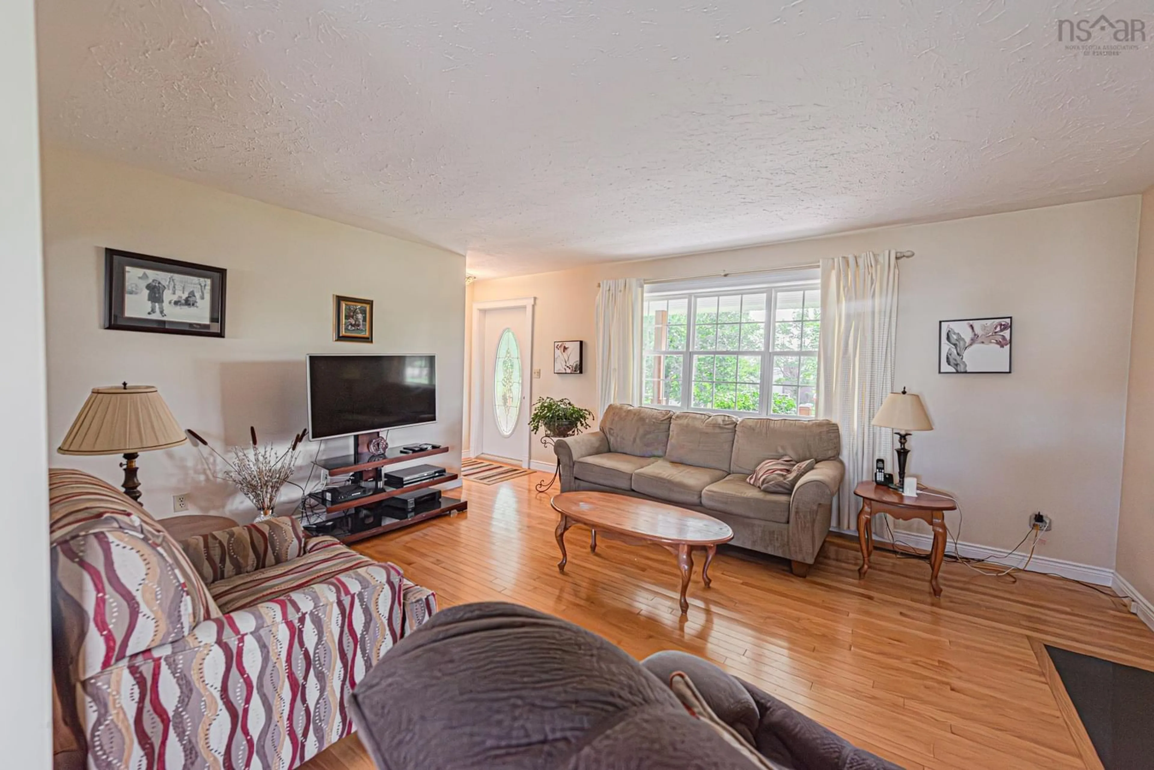 Living room with furniture, wood/laminate floor for 112 Pleasant St, Stellarton Nova Scotia B0K 1S0