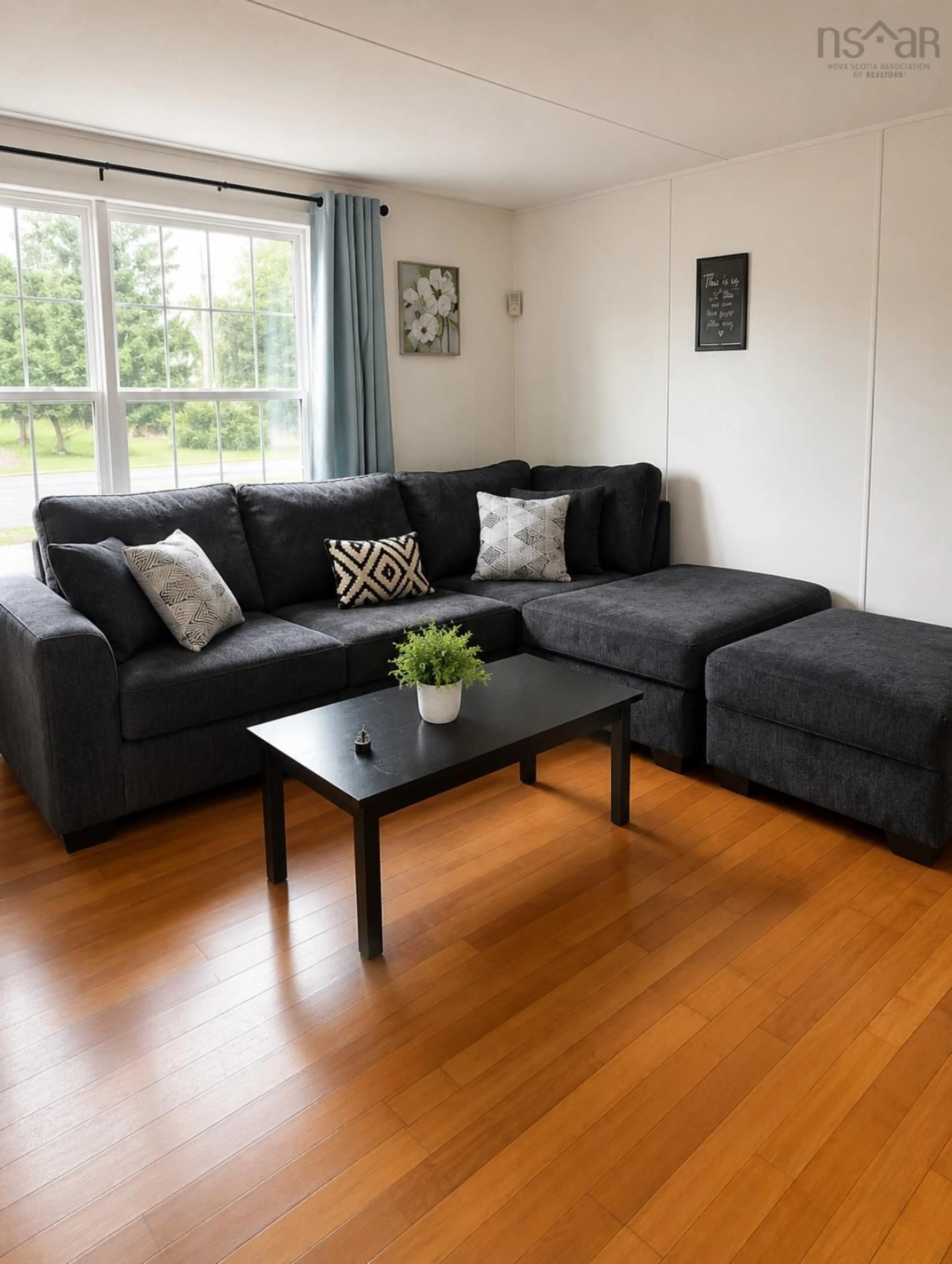 Living room with furniture, wood/laminate floor for 1001 Evans Way, Westville Nova Scotia B0K 2A0