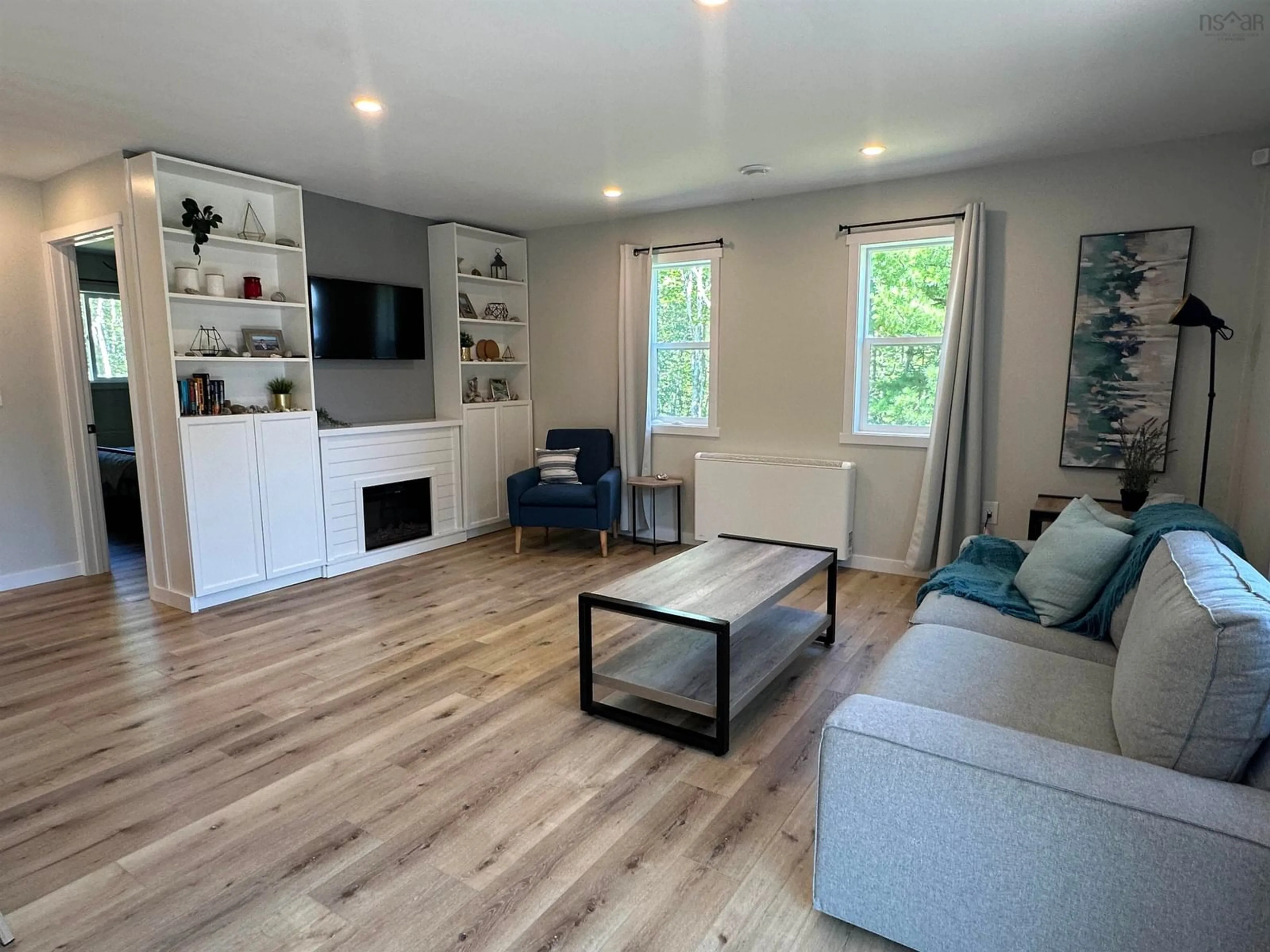Living room with furniture, wood/laminate floor for 76 Five Rivers Dr, White Point Nova Scotia B0T 1K0