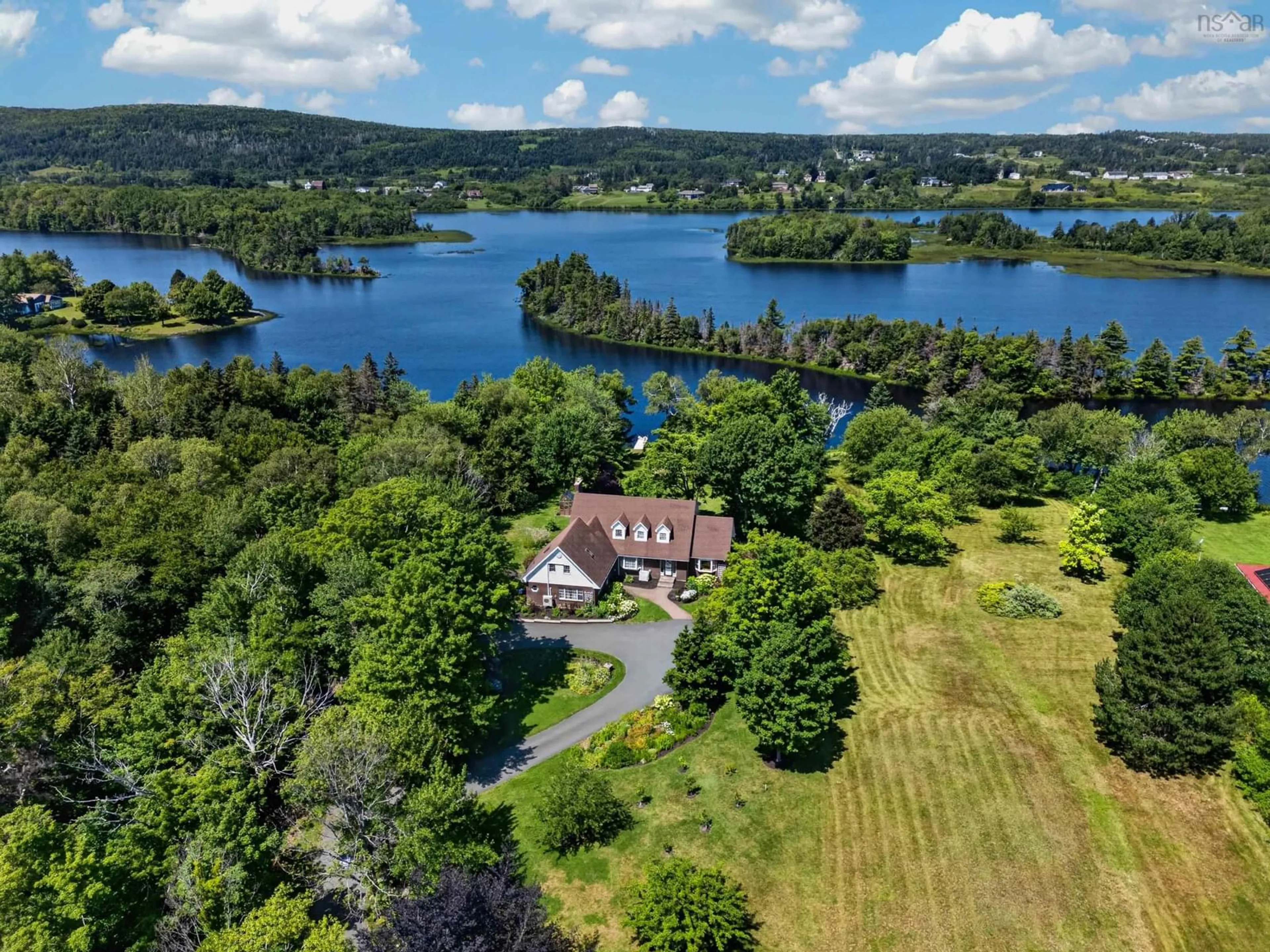 A pic from outside/outdoor area/front of a property/back of a property/a pic from drone, water/lake/river/ocean view for 1864 Kings Rd, Sydney River Nova Scotia B1L 1C5