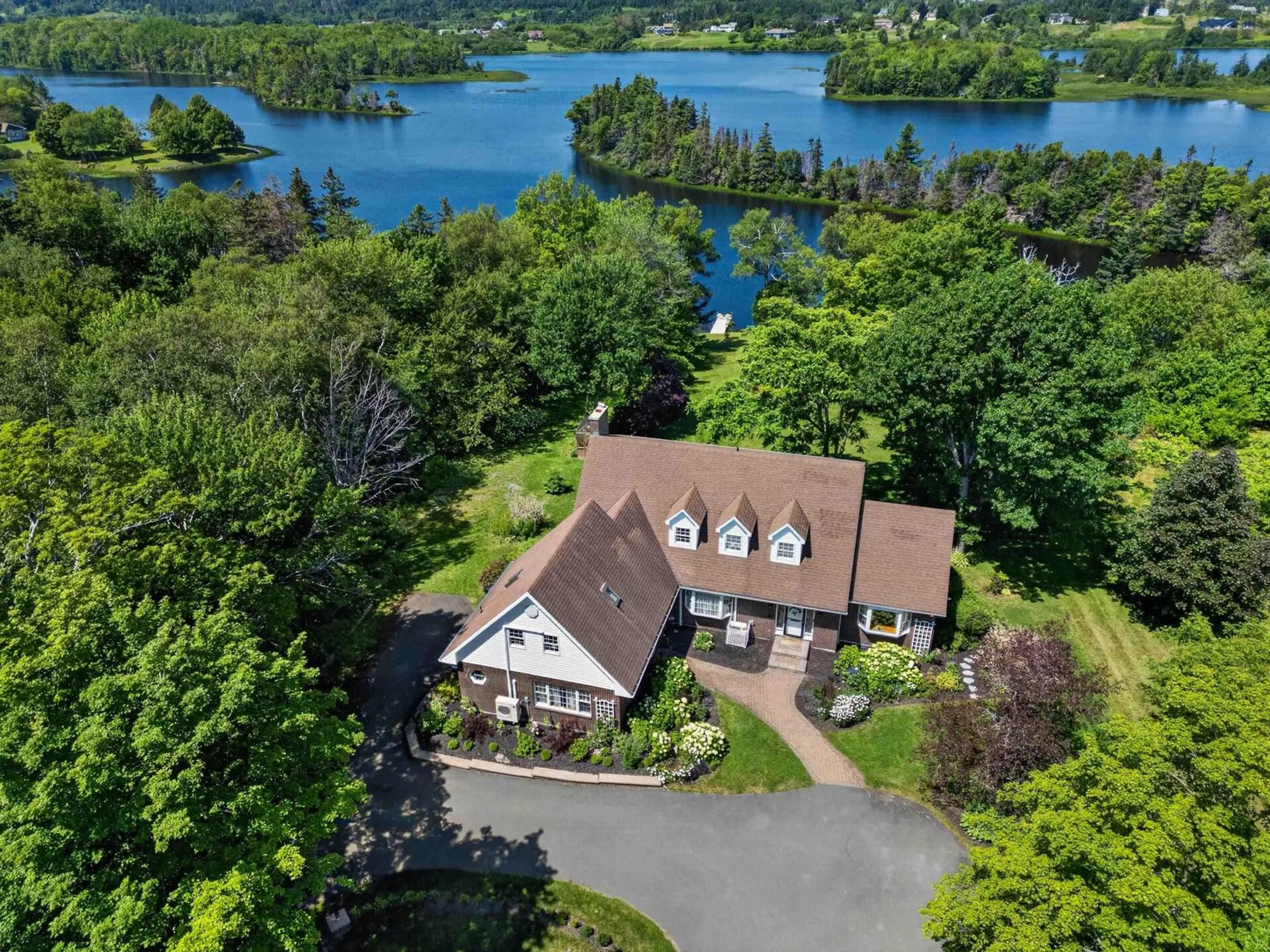 A pic from outside/outdoor area/front of a property/back of a property/a pic from drone, water/lake/river/ocean view for 1864 Kings Rd, Sydney River Nova Scotia B1L 1C5