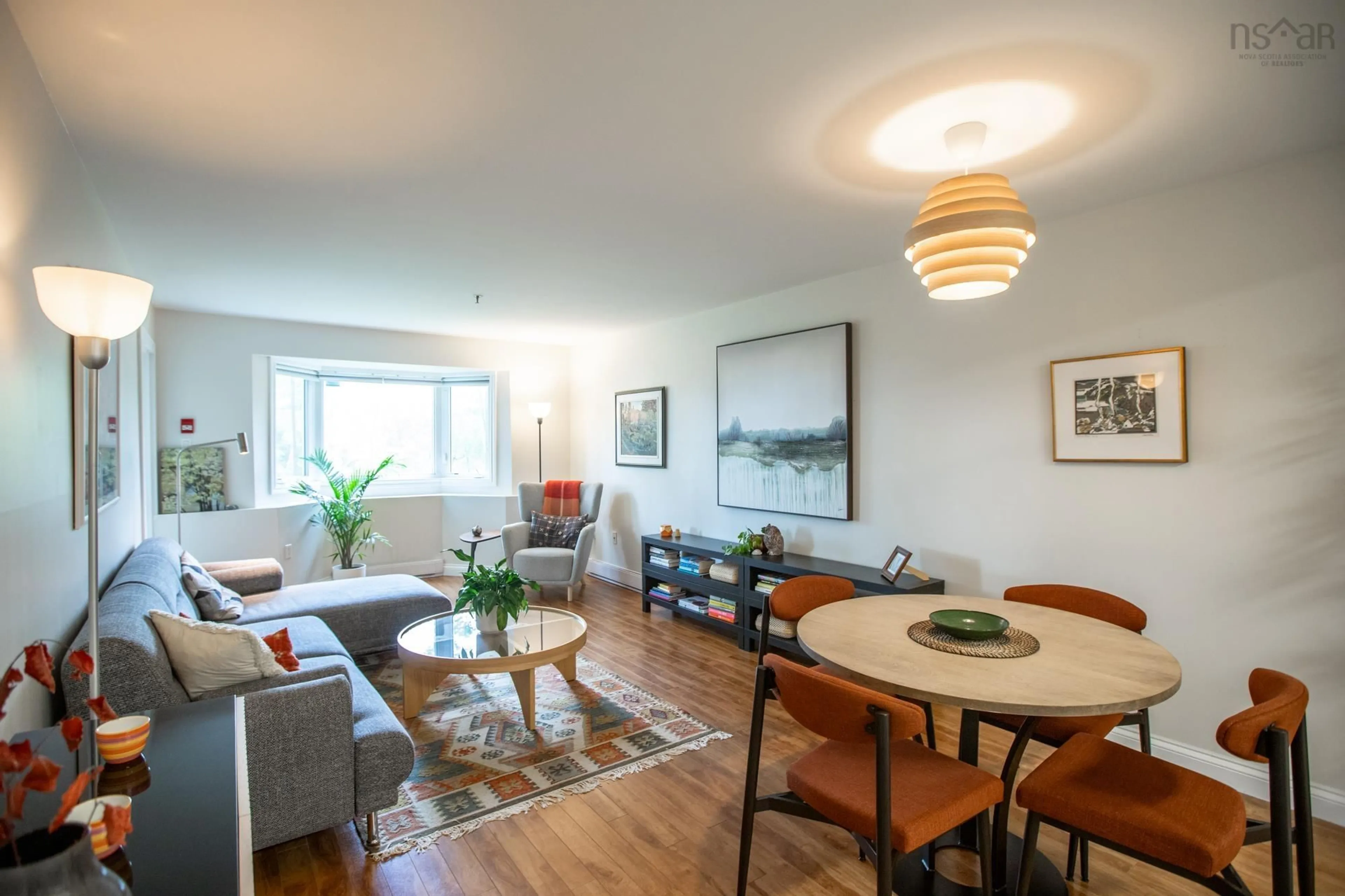 Living room with furniture, wood/laminate floor for 87 Kearney Lake Rd #104, Halifax Nova Scotia B3M 4H1