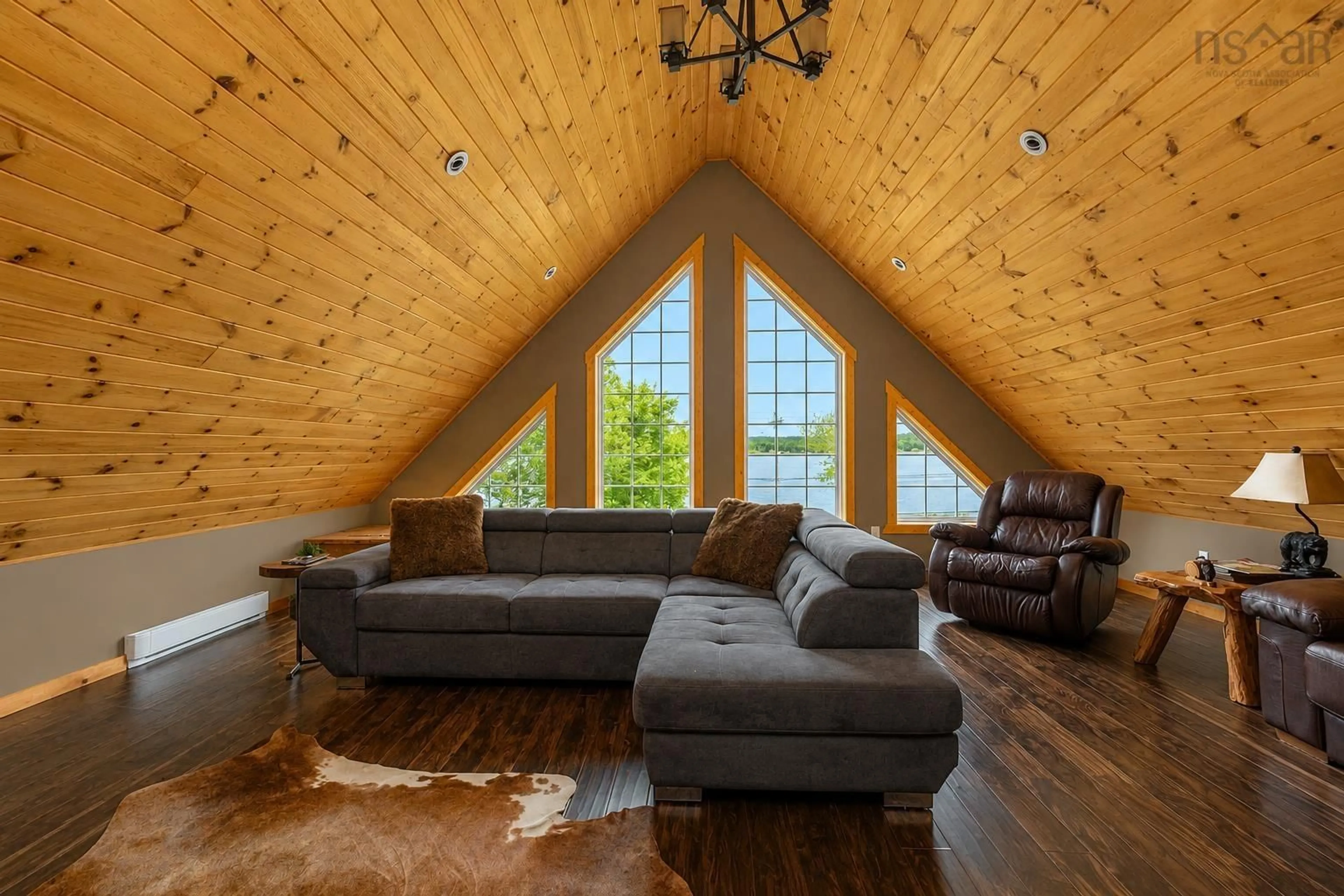 Living room with furniture, wood/laminate floor for 1774 Hillside Rd, Marion Bridge Nova Scotia B1K 3N4