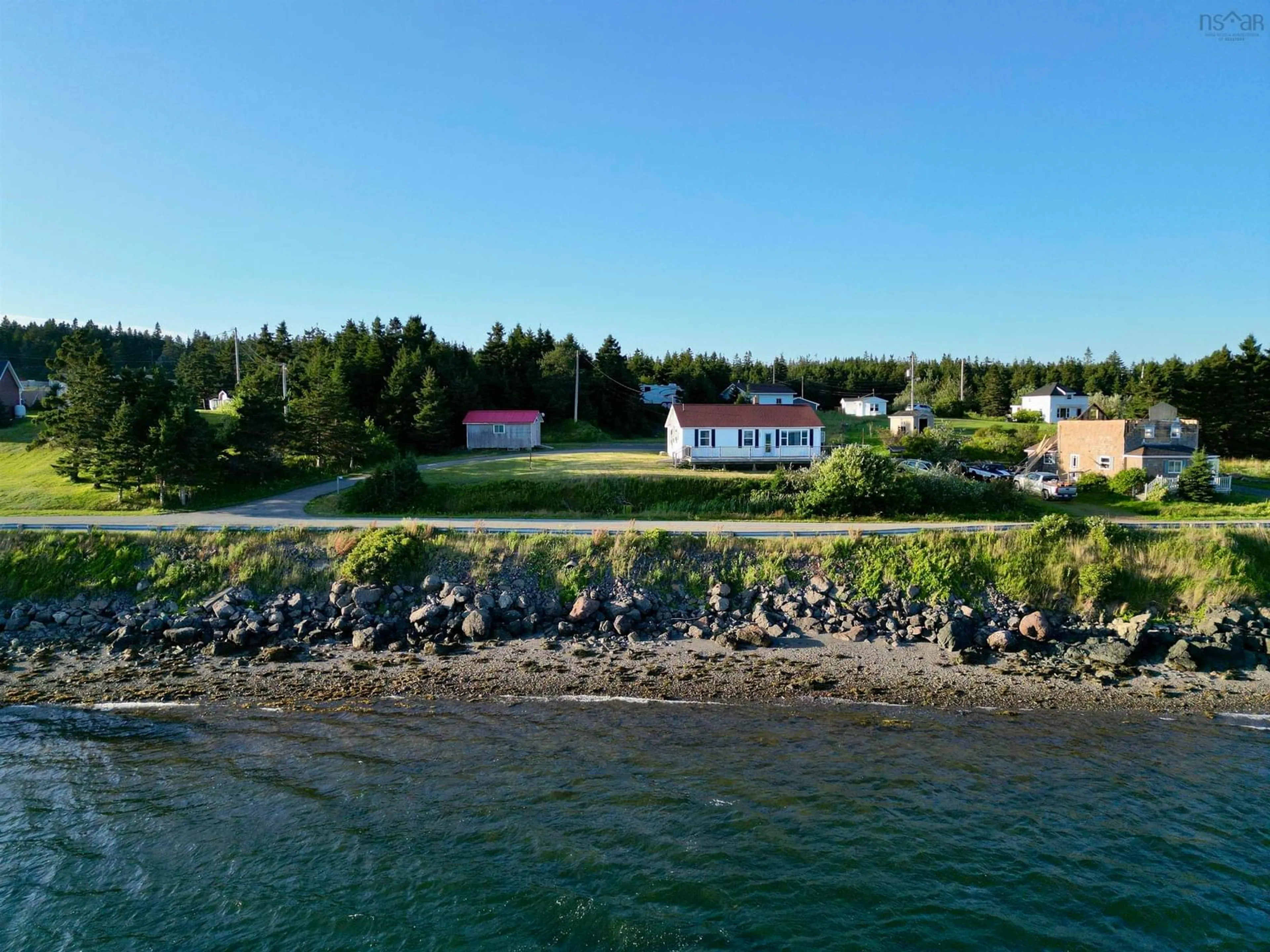A pic from outside/outdoor area/front of a property/back of a property/a pic from drone, water/lake/river/ocean view for 205 Veterans Memorial Dr., Arichat Nova Scotia B0E 1A0