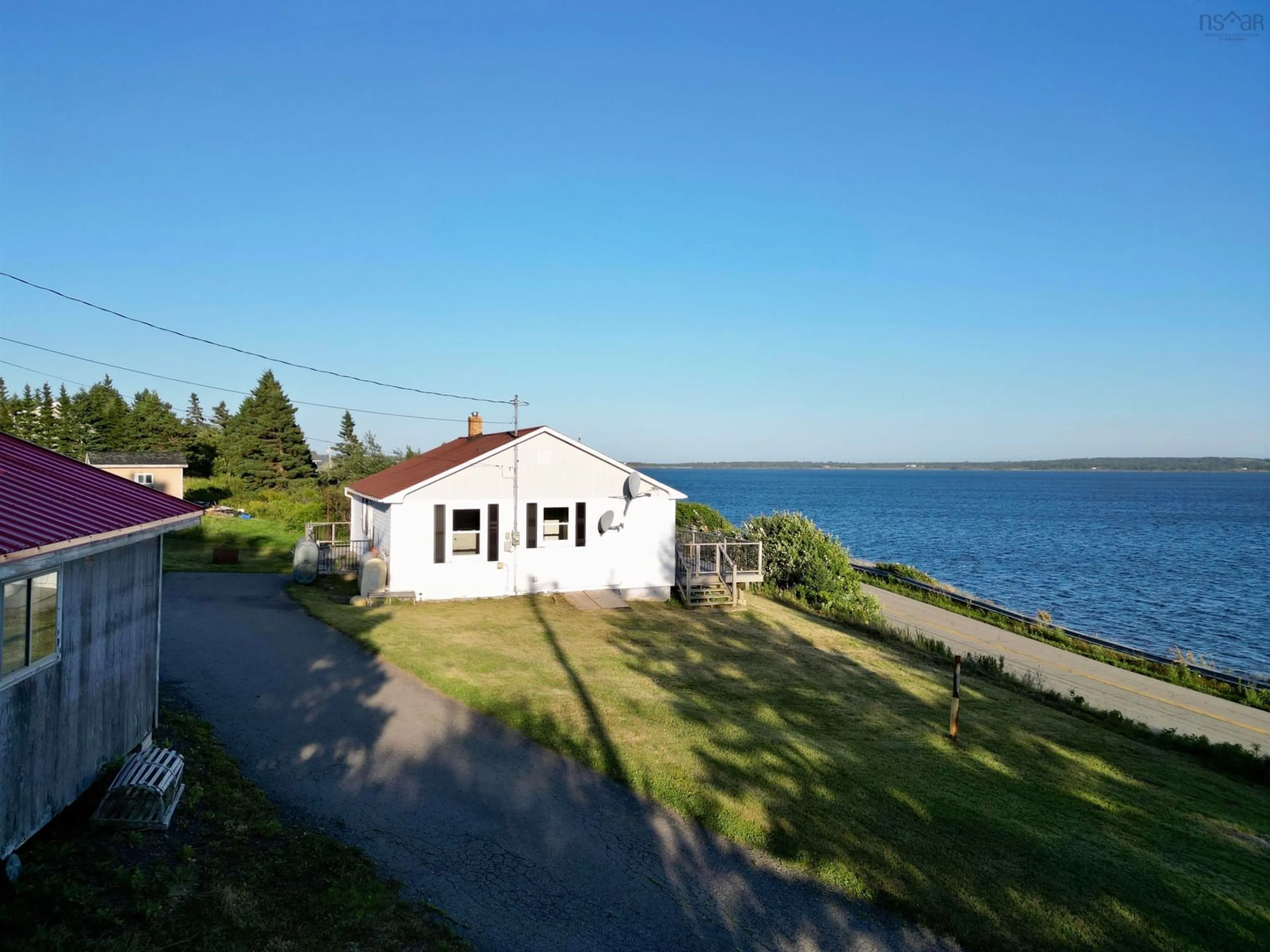 A pic from outside/outdoor area/front of a property/back of a property/a pic from drone, water/lake/river/ocean view for 205 Veterans Memorial Dr., Arichat Nova Scotia B0E 1A0