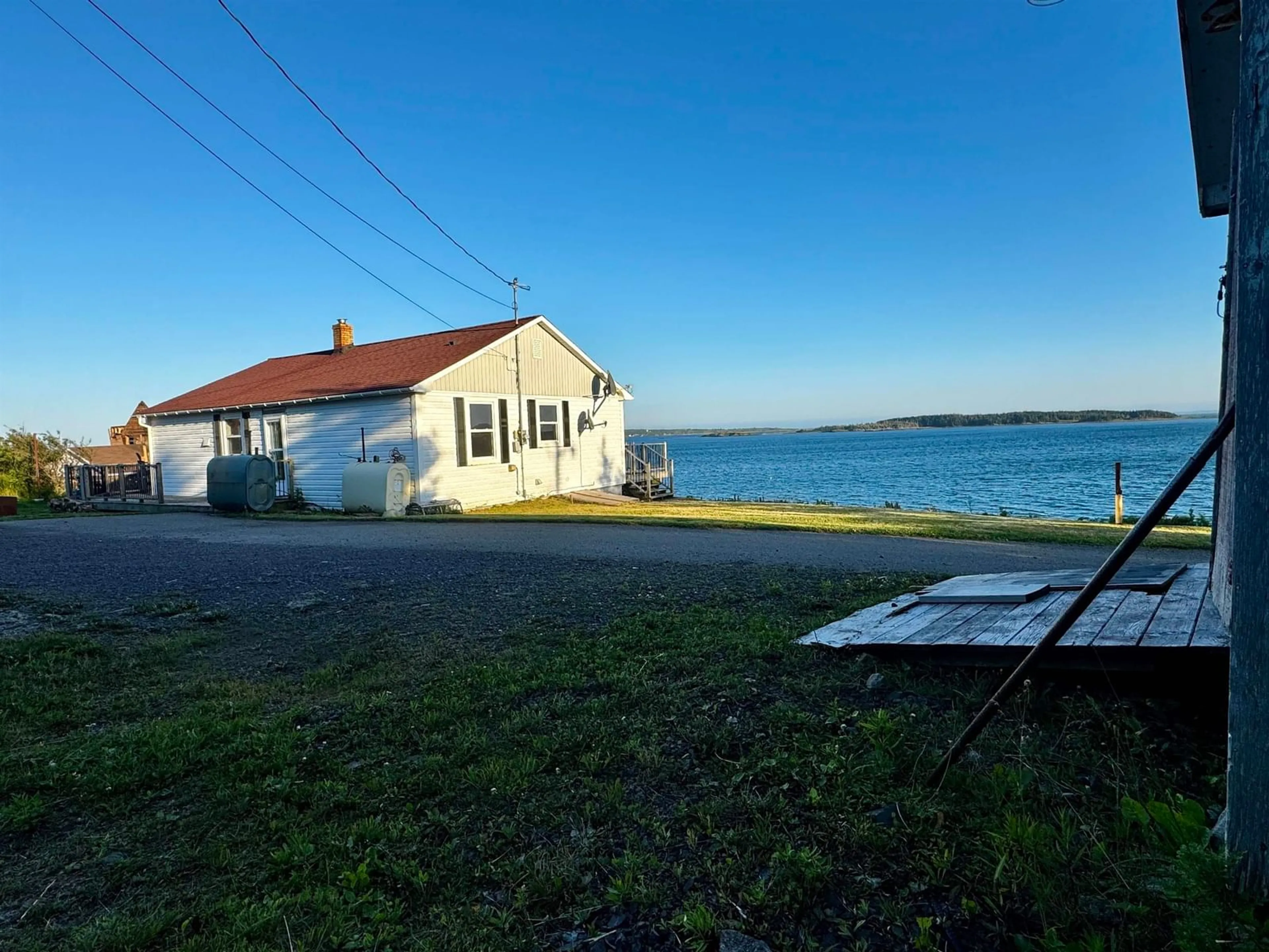 A pic from outside/outdoor area/front of a property/back of a property/a pic from drone, water/lake/river/ocean view for 205 Veterans Memorial Dr., Arichat Nova Scotia B0E 1A0