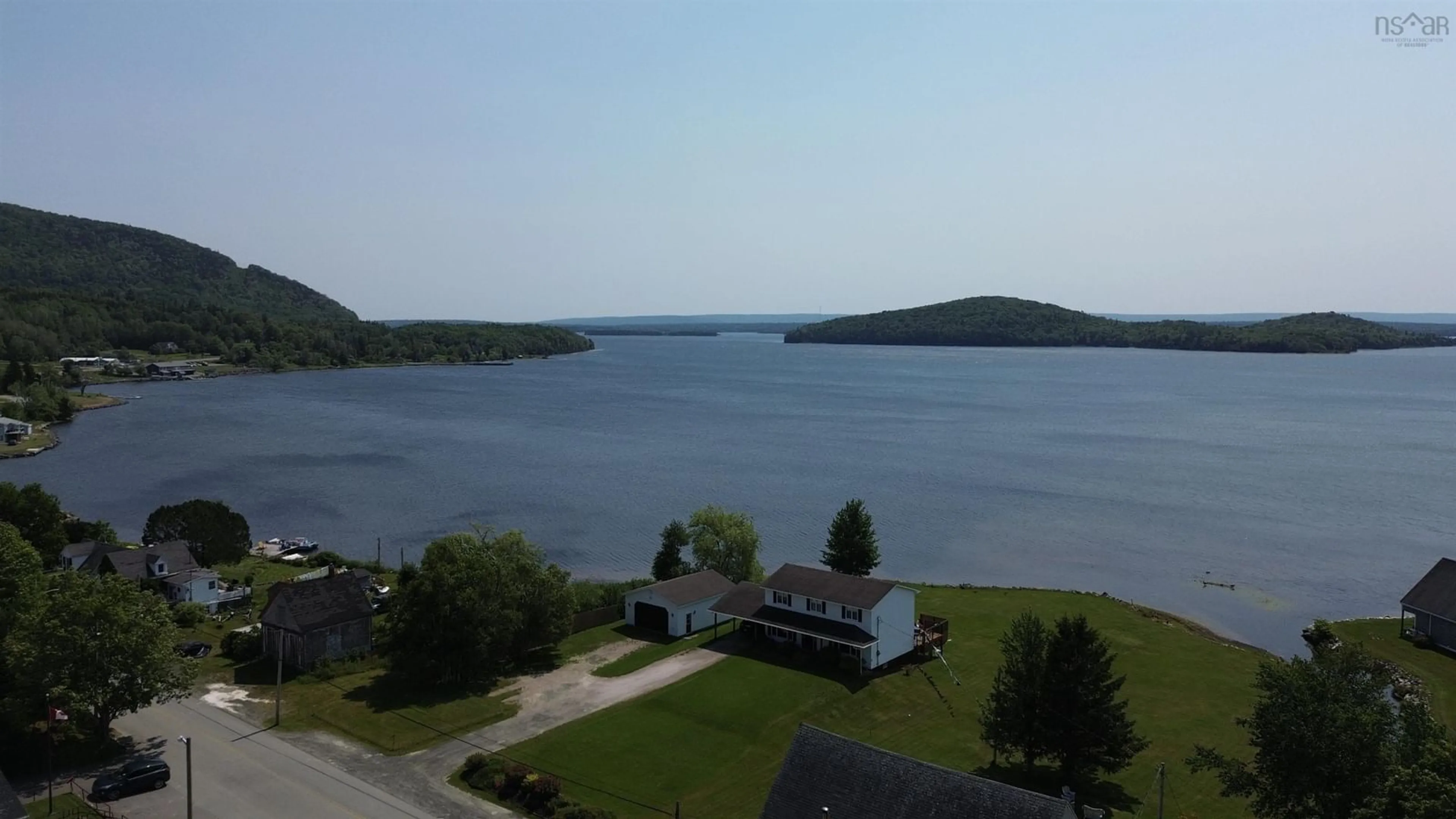 A pic from outside/outdoor area/front of a property/back of a property/a pic from drone, water/lake/river/ocean view for 109 Main Street, Whycocomagh Nova Scotia B0E 3M0