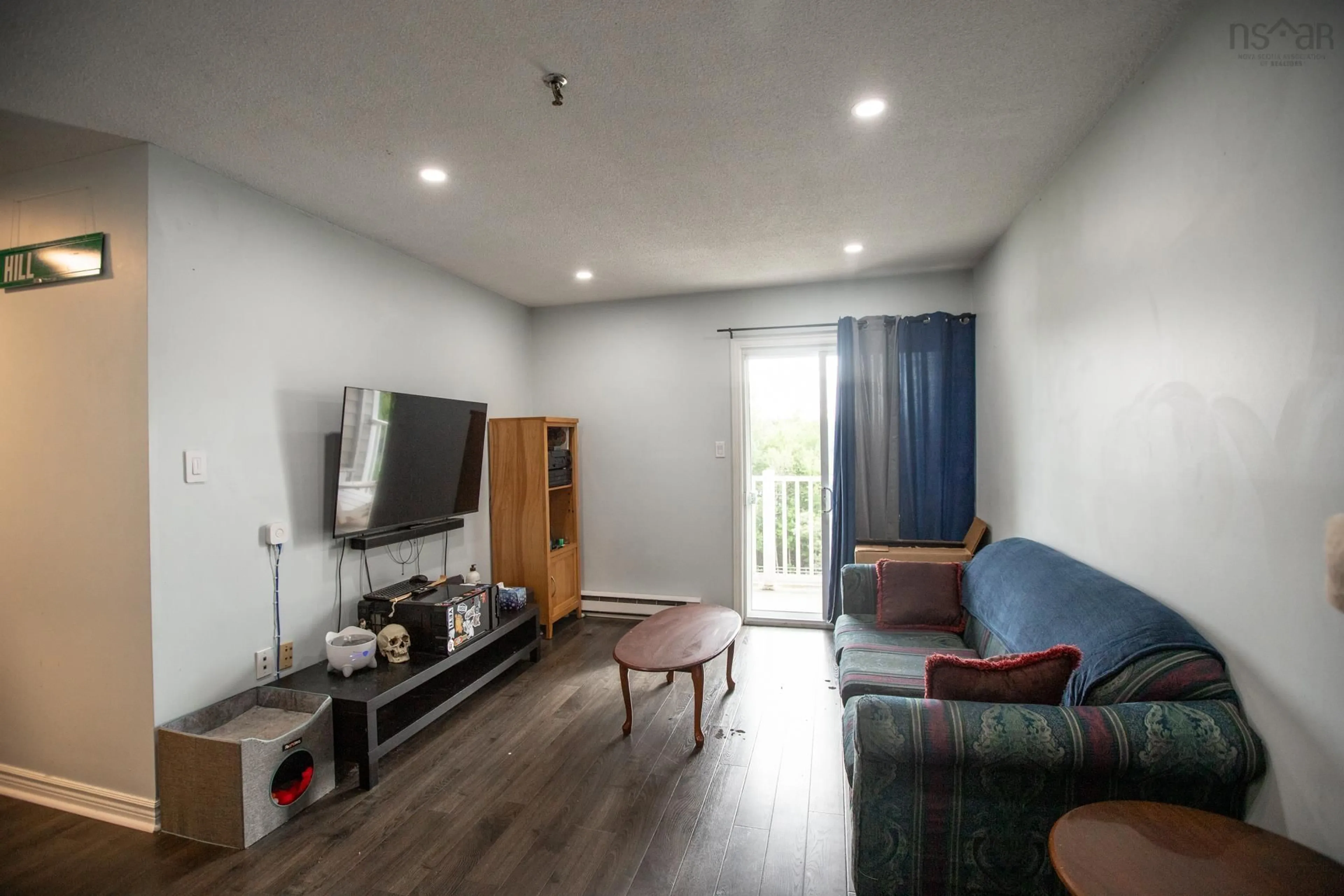 Living room with furniture, wood/laminate floor for 15 Langbrae Dr #303, Clayton Park Nova Scotia B3M 3W5