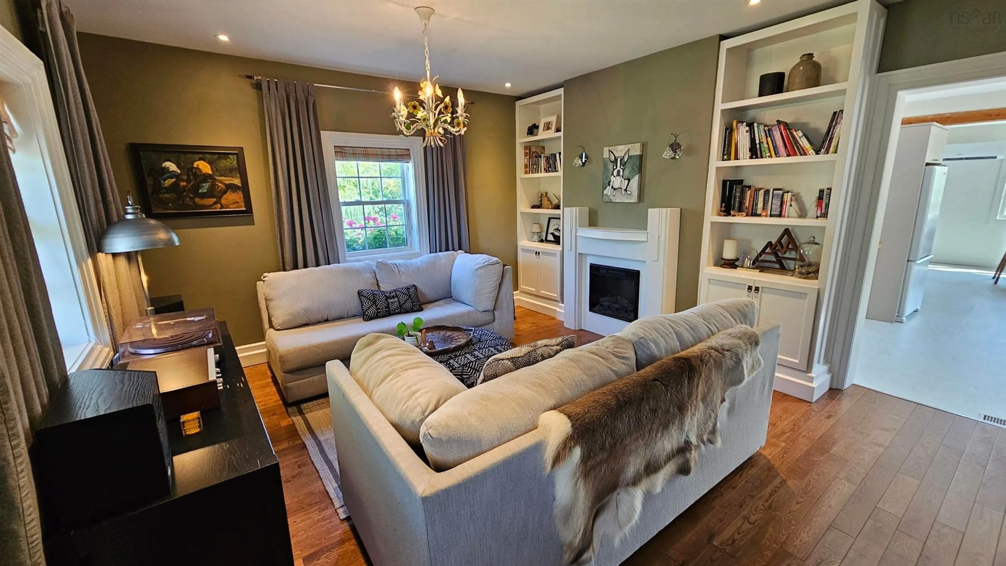 Living room with furniture, wood/laminate floor for 6896 Highway 2, Portapique Nova Scotia B0M 1B0