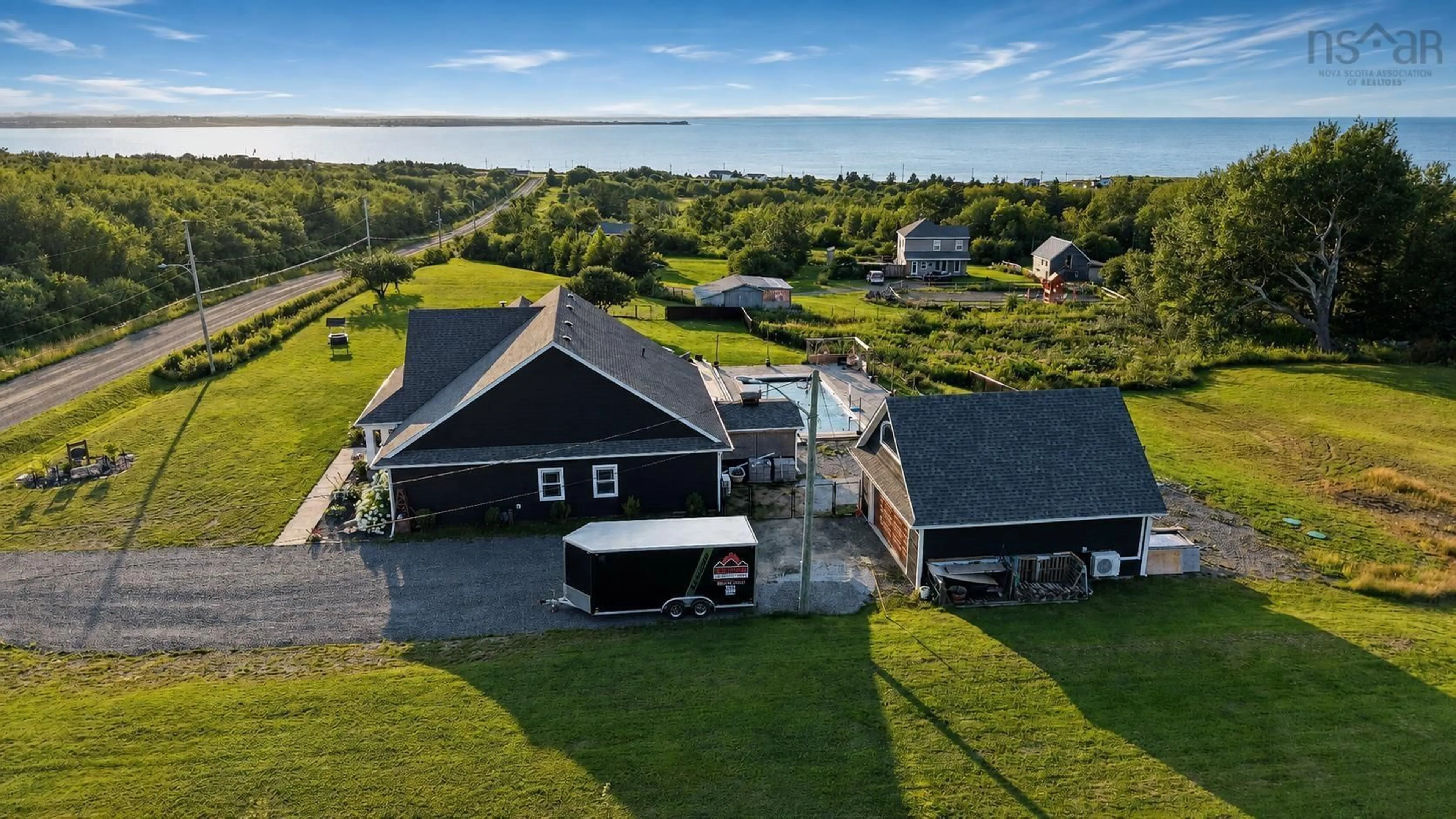 A pic from outside/outdoor area/front of a property/back of a property/a pic from drone, water/lake/river/ocean view for 127 Lake Rd, Victoria Mines Nova Scotia B1N 3J7