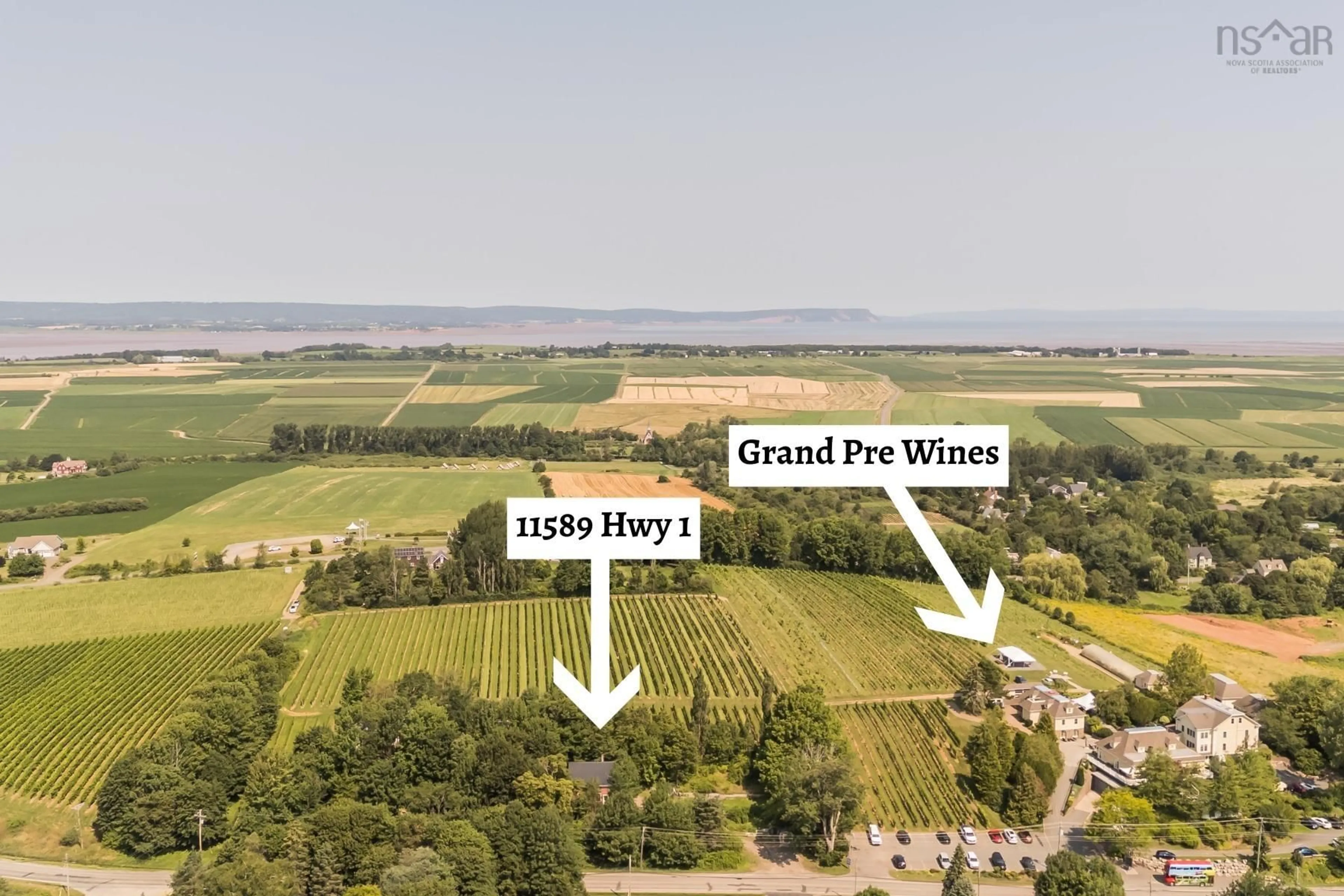 A pic from outside/outdoor area/front of a property/back of a property/a pic from drone, water/lake/river/ocean view for 11589 Highway 1, Grand Pré Nova Scotia B0P 1M0