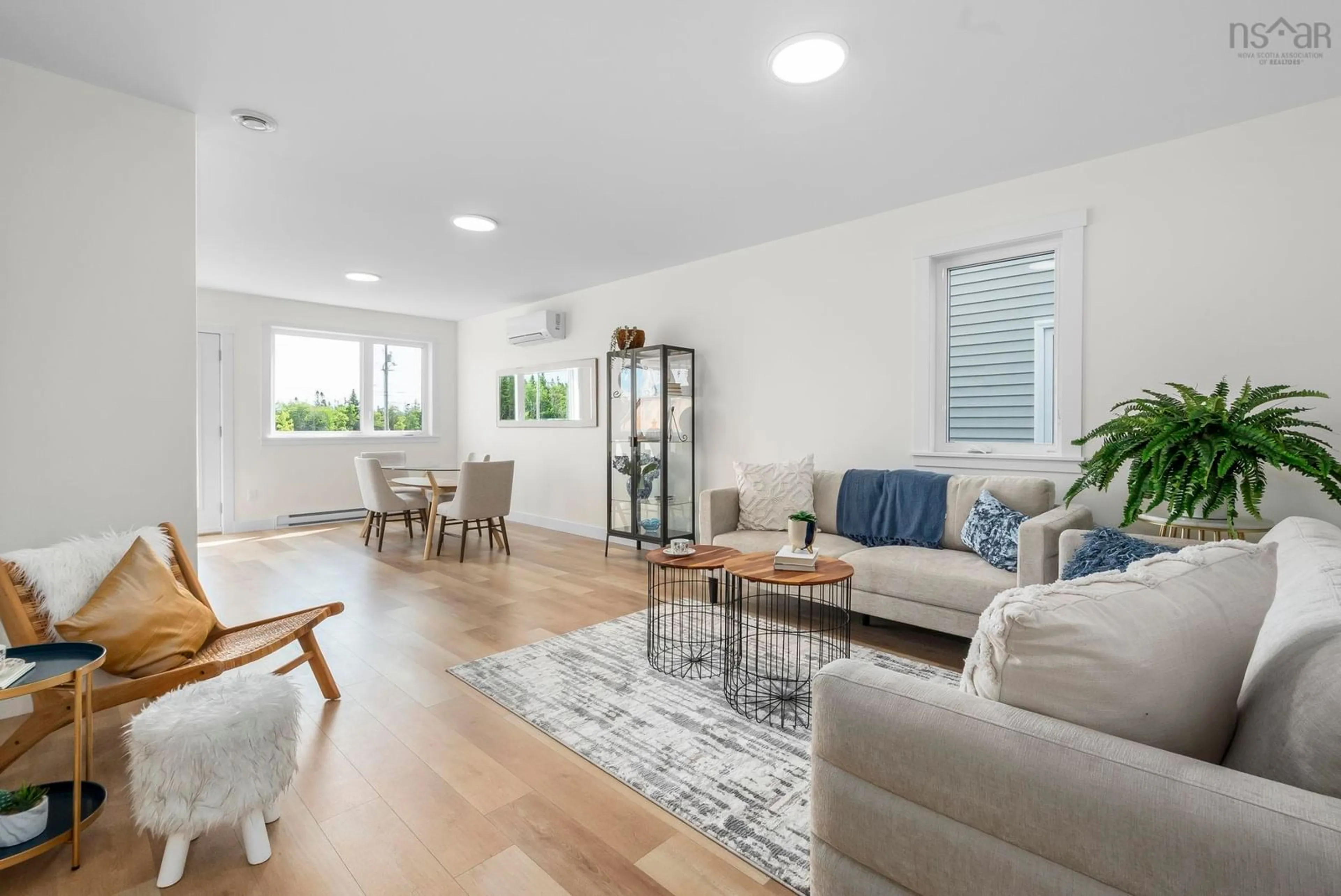Living room with furniture, wood/laminate floor for 42 Berm St, Spryfield Nova Scotia B3R 0H2