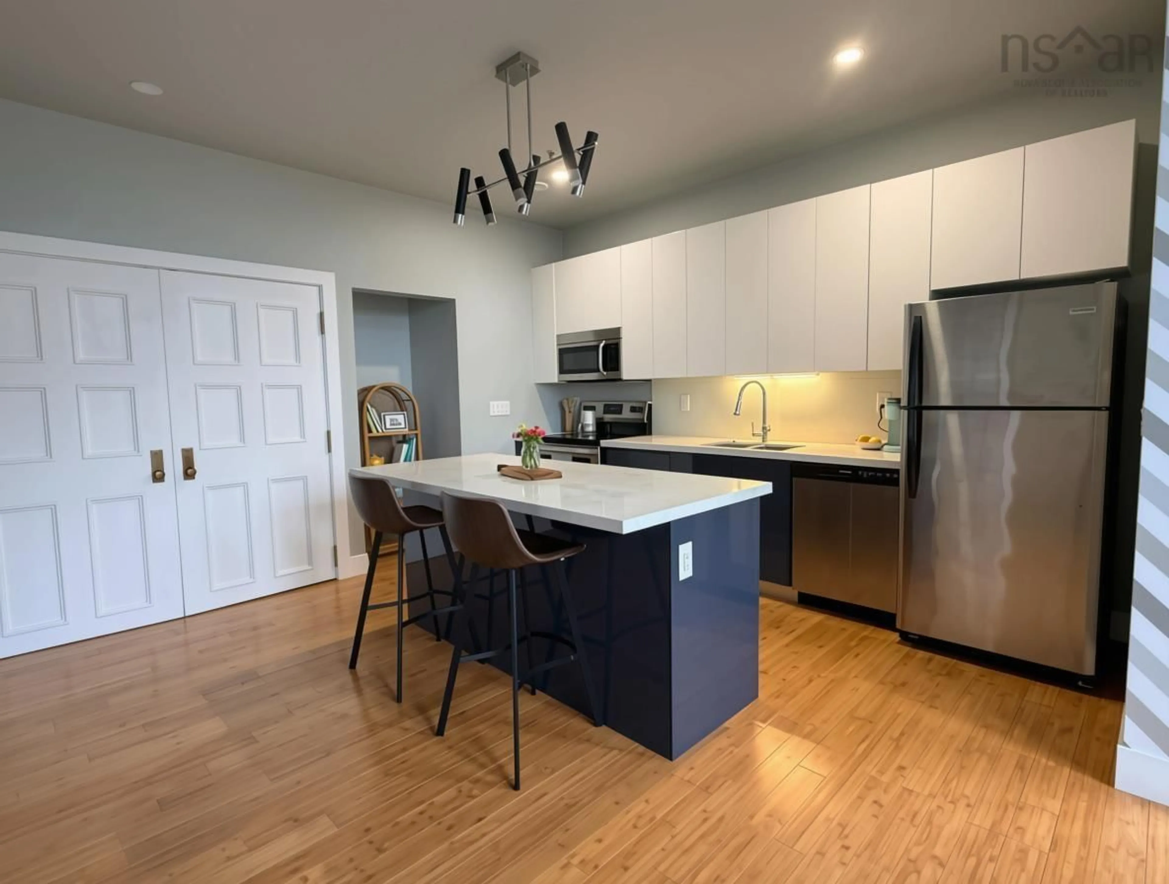Open concept kitchen, wood/laminate floor for 151 Ritchie St #304, Annapolis Royal Nova Scotia B0S 1A0