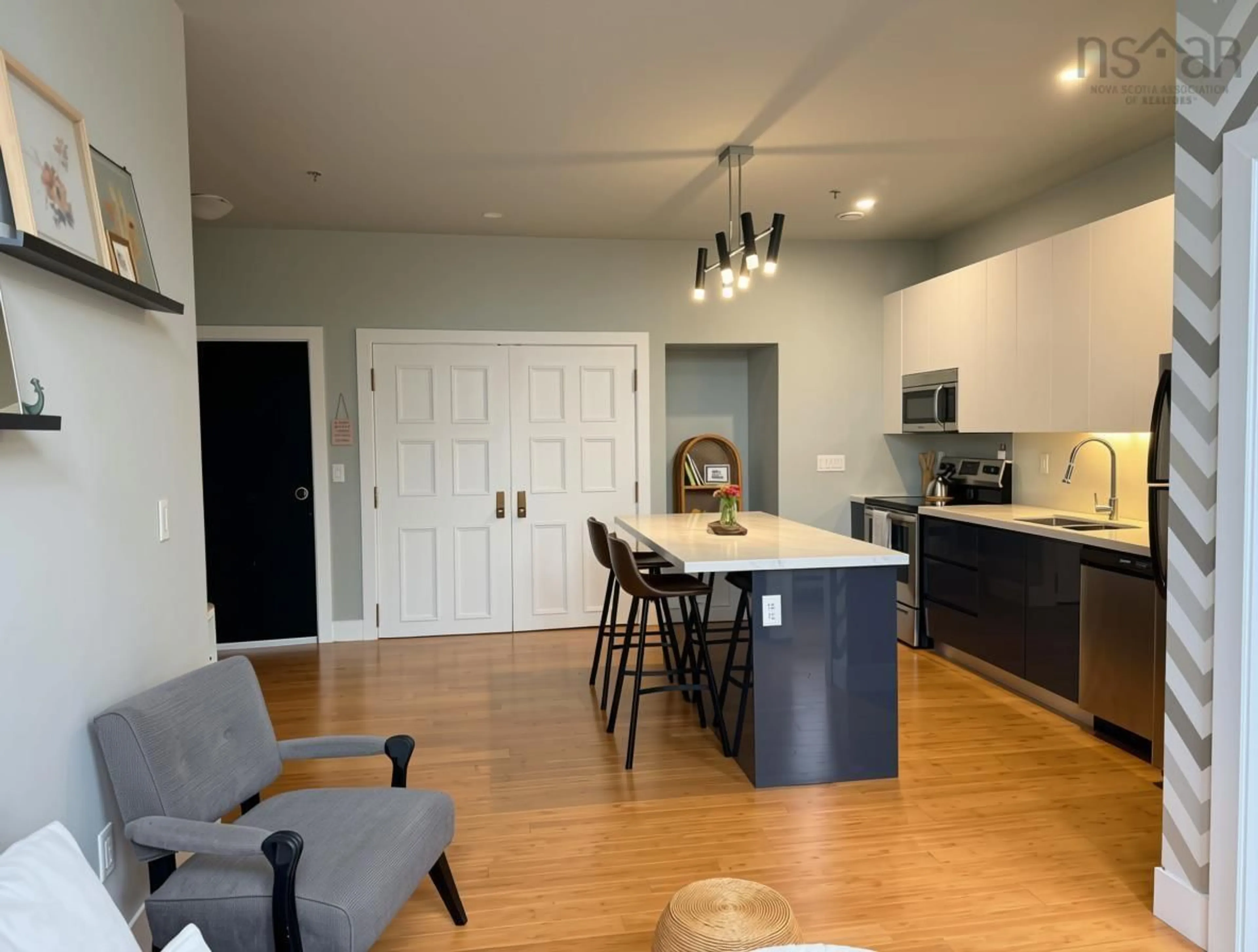 Open concept kitchen, wood/laminate floor for 151 Ritchie St #304, Annapolis Royal Nova Scotia B0S 1A0