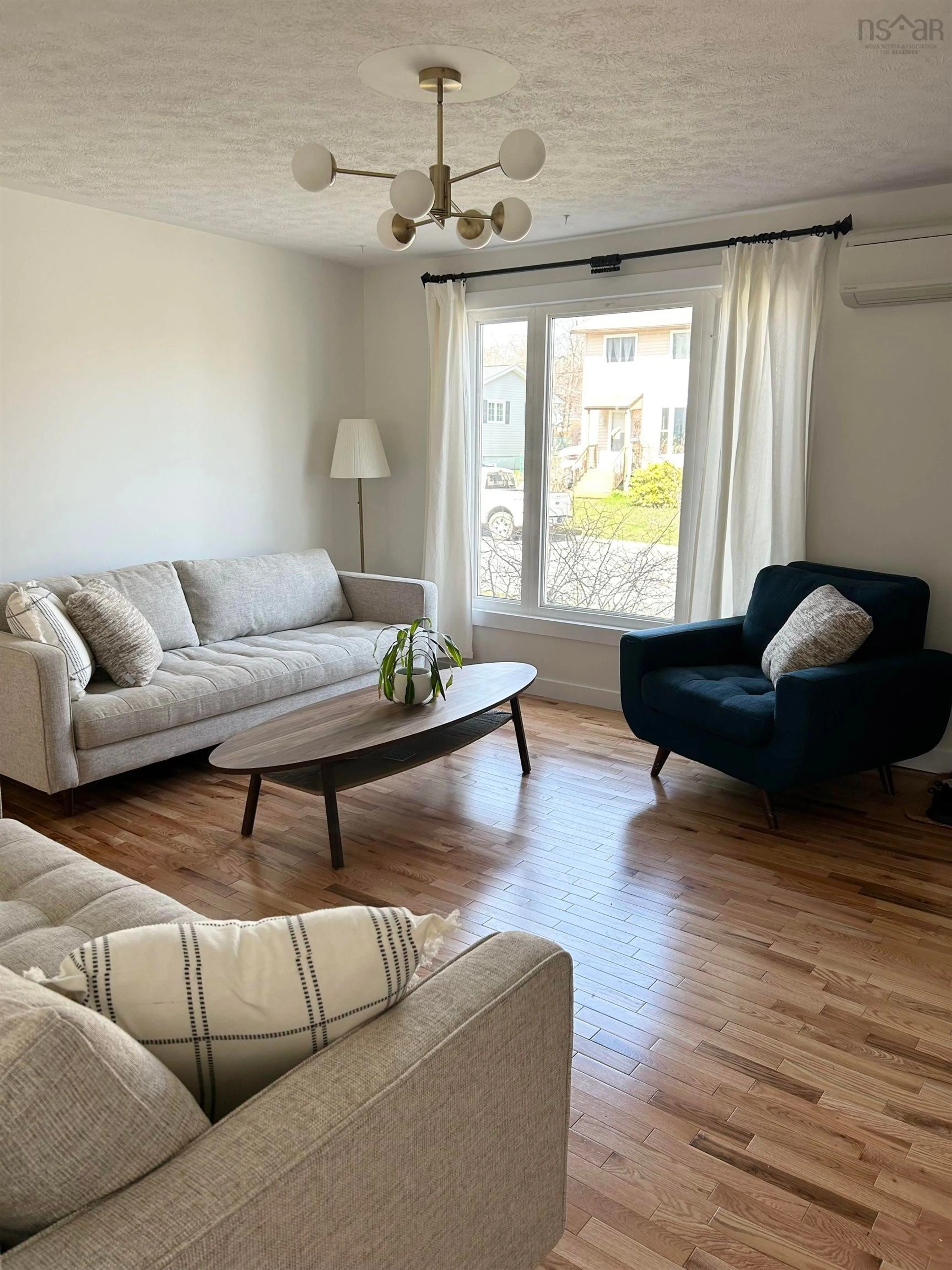 Living room with furniture, wood/laminate floor for 26 Lynnville Dr, Sackville Nova Scotia B4C 2H8
