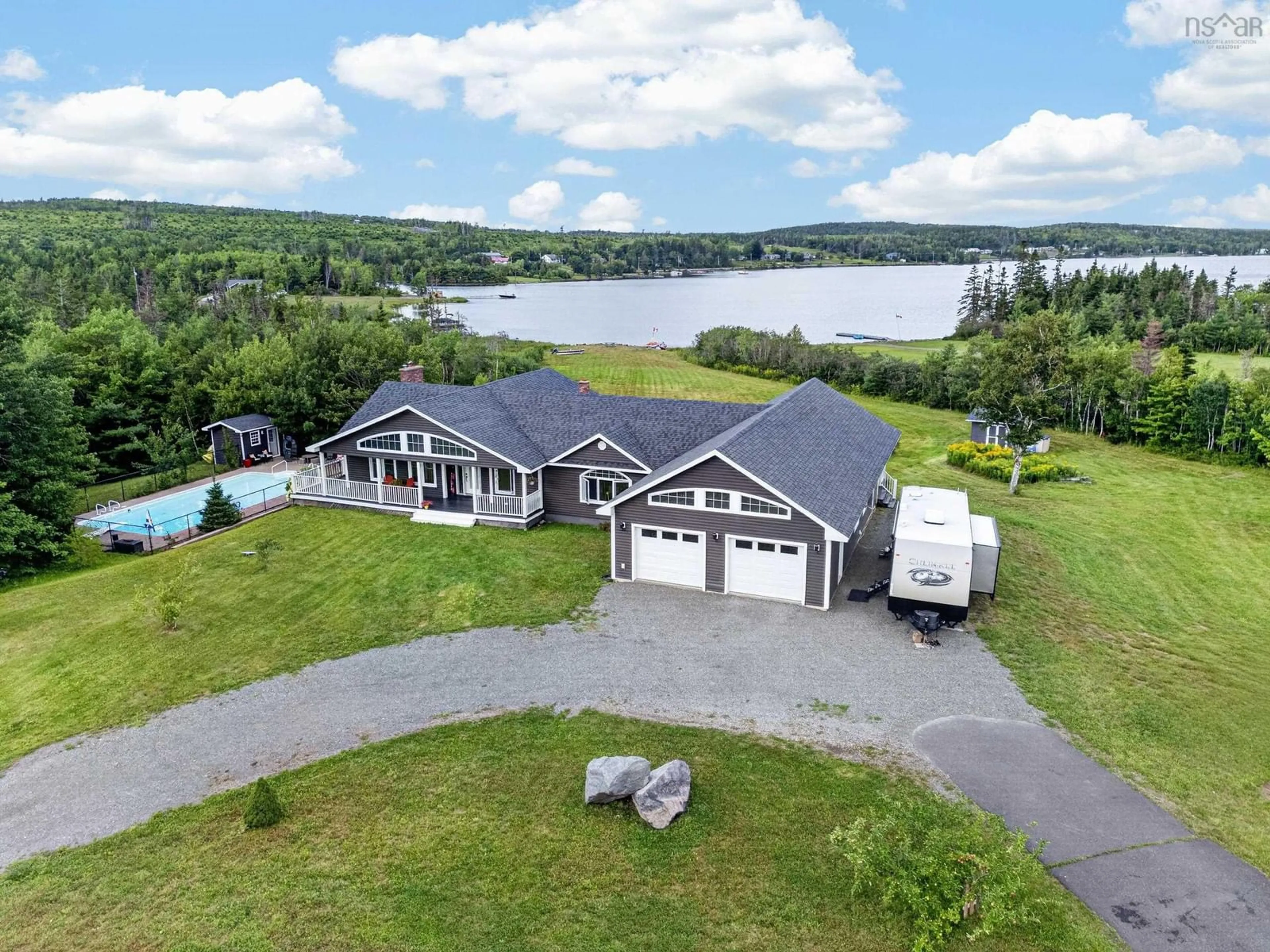 A pic from outside/outdoor area/front of a property/back of a property/a pic from drone, water/lake/river/ocean view for 131 Oakfield Dr, Marion Bridge Nova Scotia B1K 3N8