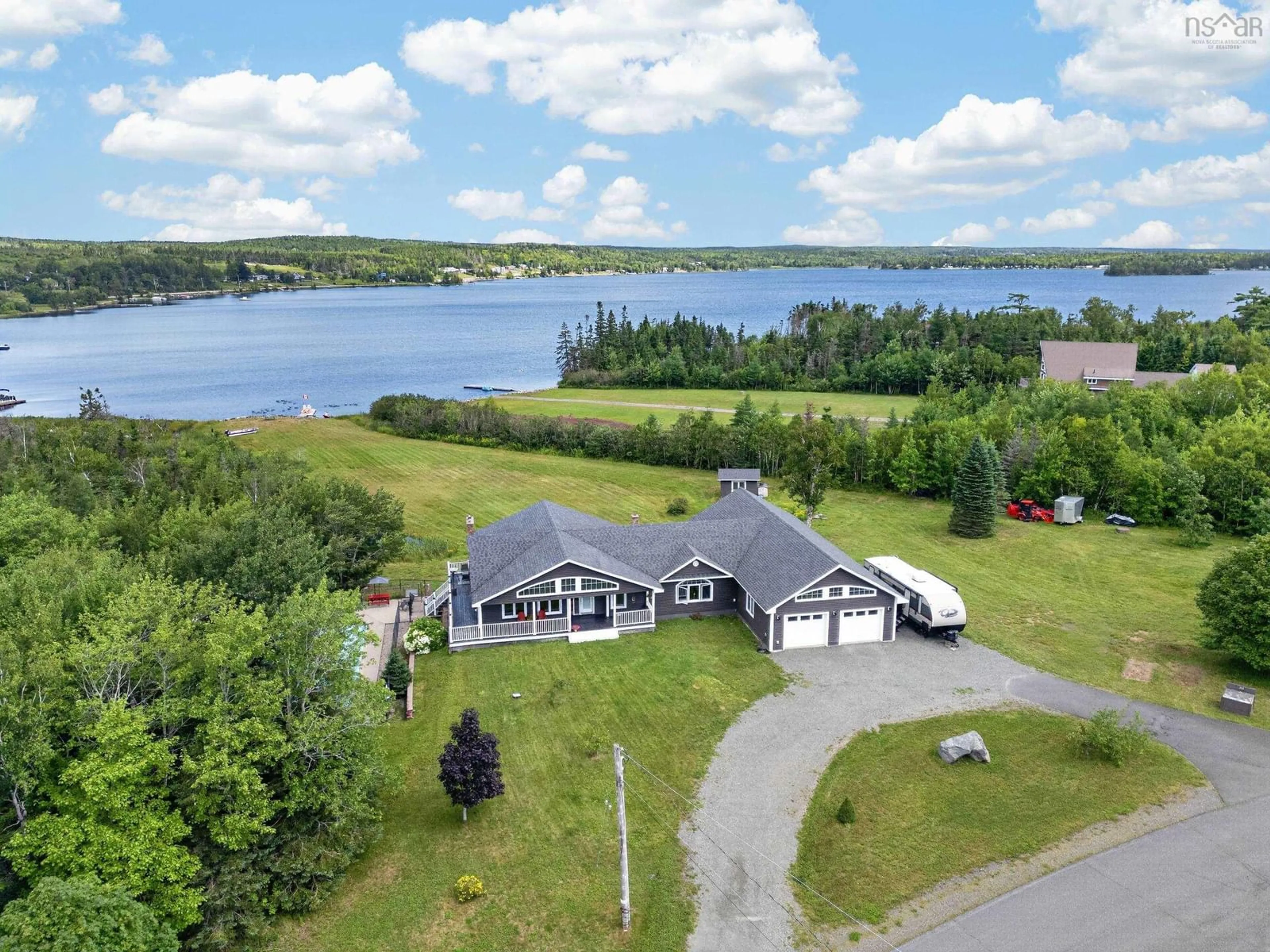 A pic from outside/outdoor area/front of a property/back of a property/a pic from drone, water/lake/river/ocean view for 131 Oakfield Dr, Marion Bridge Nova Scotia B1K 3N8