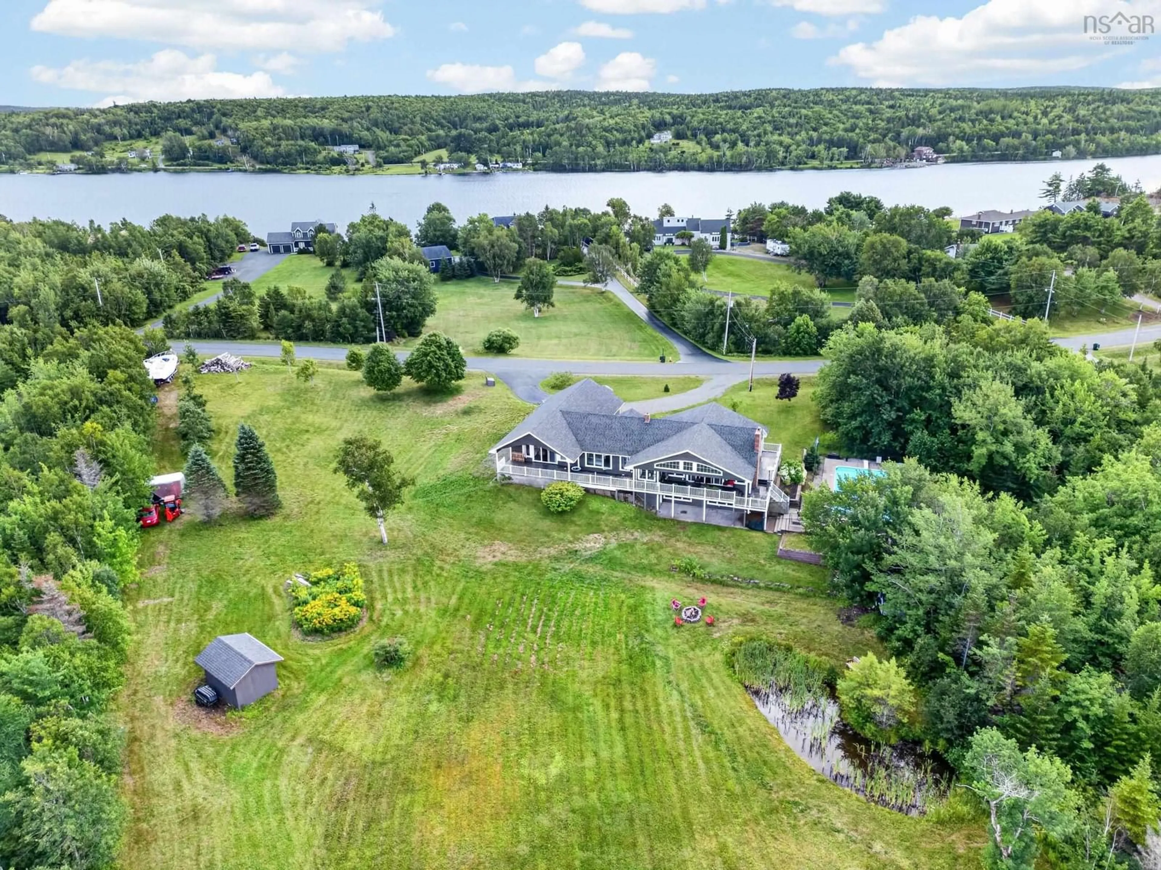 A pic from outside/outdoor area/front of a property/back of a property/a pic from drone, water/lake/river/ocean view for 131 Oakfield Dr, Marion Bridge Nova Scotia B1K 3N8