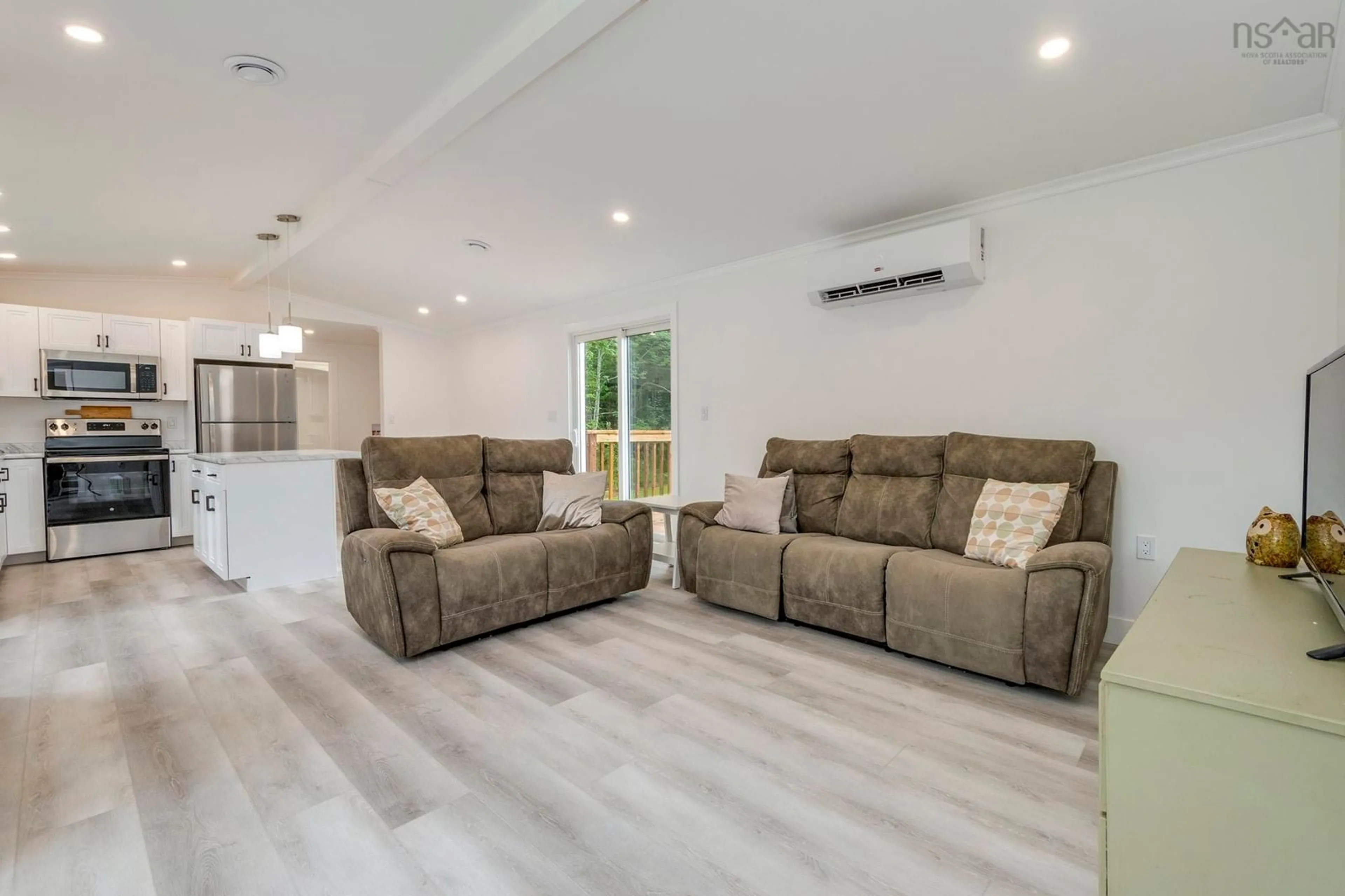 Living room with furniture, wood/laminate floor for 7200 Highway 6, Three Brooks Nova Scotia B0K 1H0