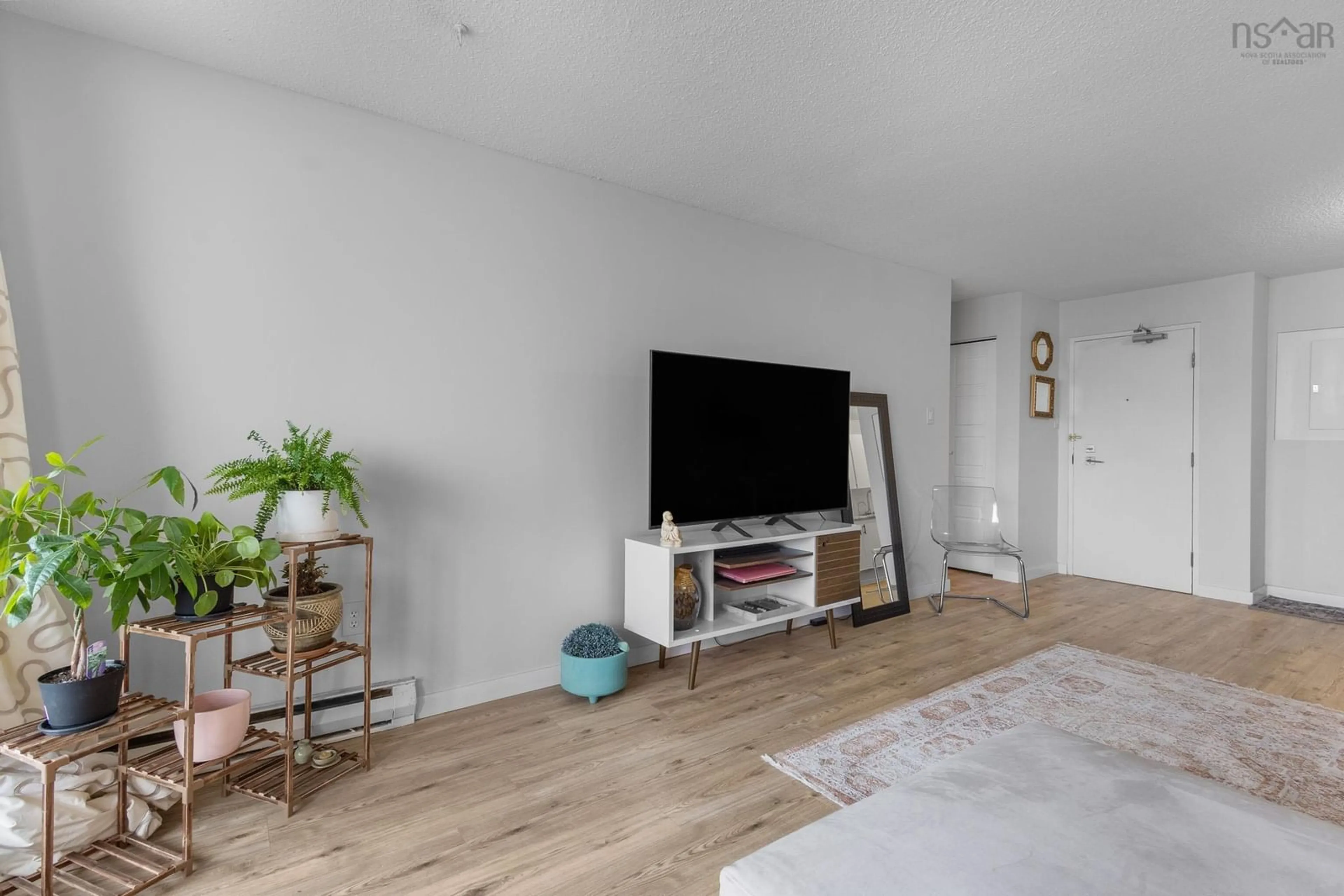 Living room with furniture, wood/laminate floor for 5572 North Ridge Rd #1002, Halifax Nova Scotia B3K 5K2