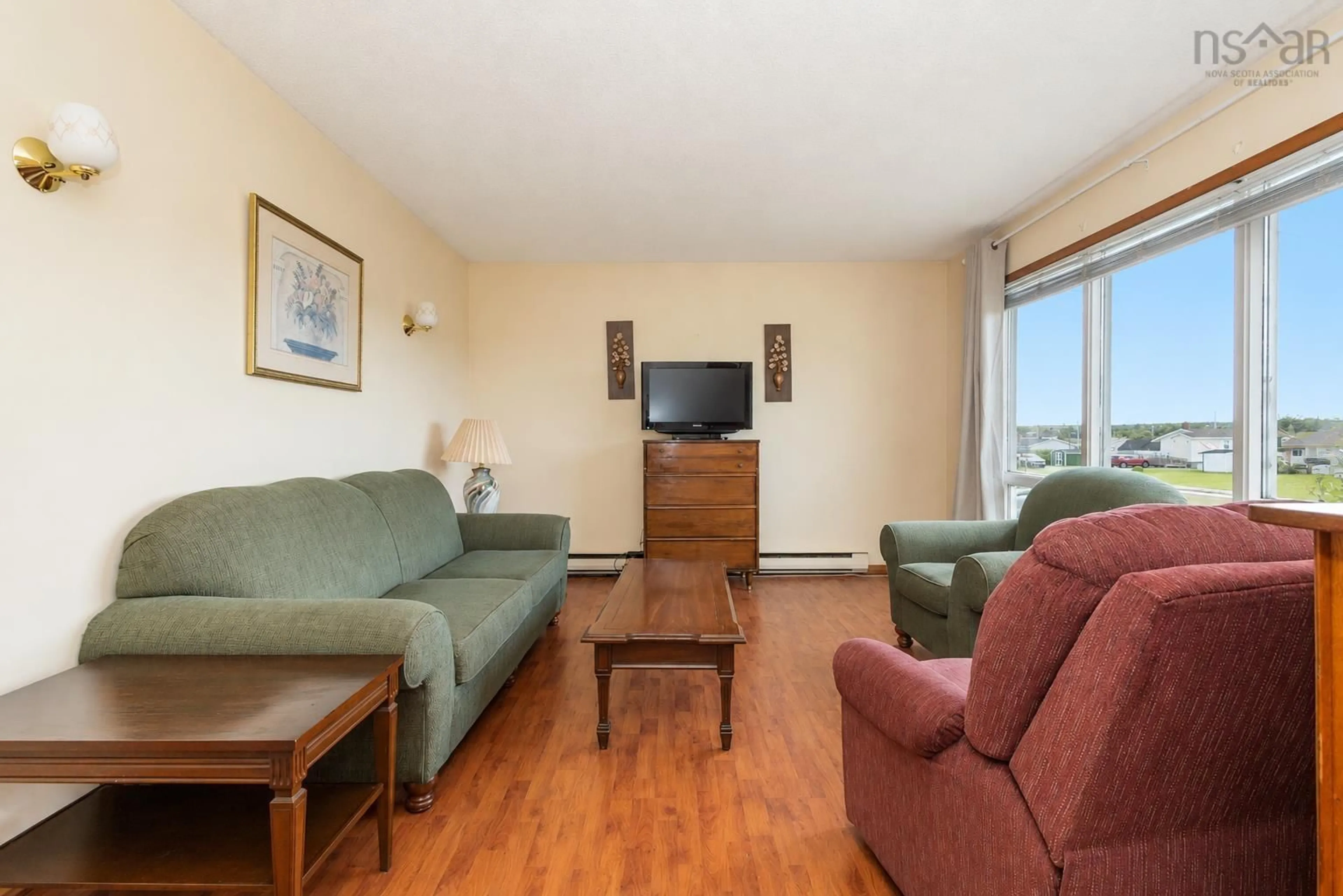 Living room with furniture, wood/laminate floor for 46 Row St, Glace Bay Nova Scotia B1A 4T7