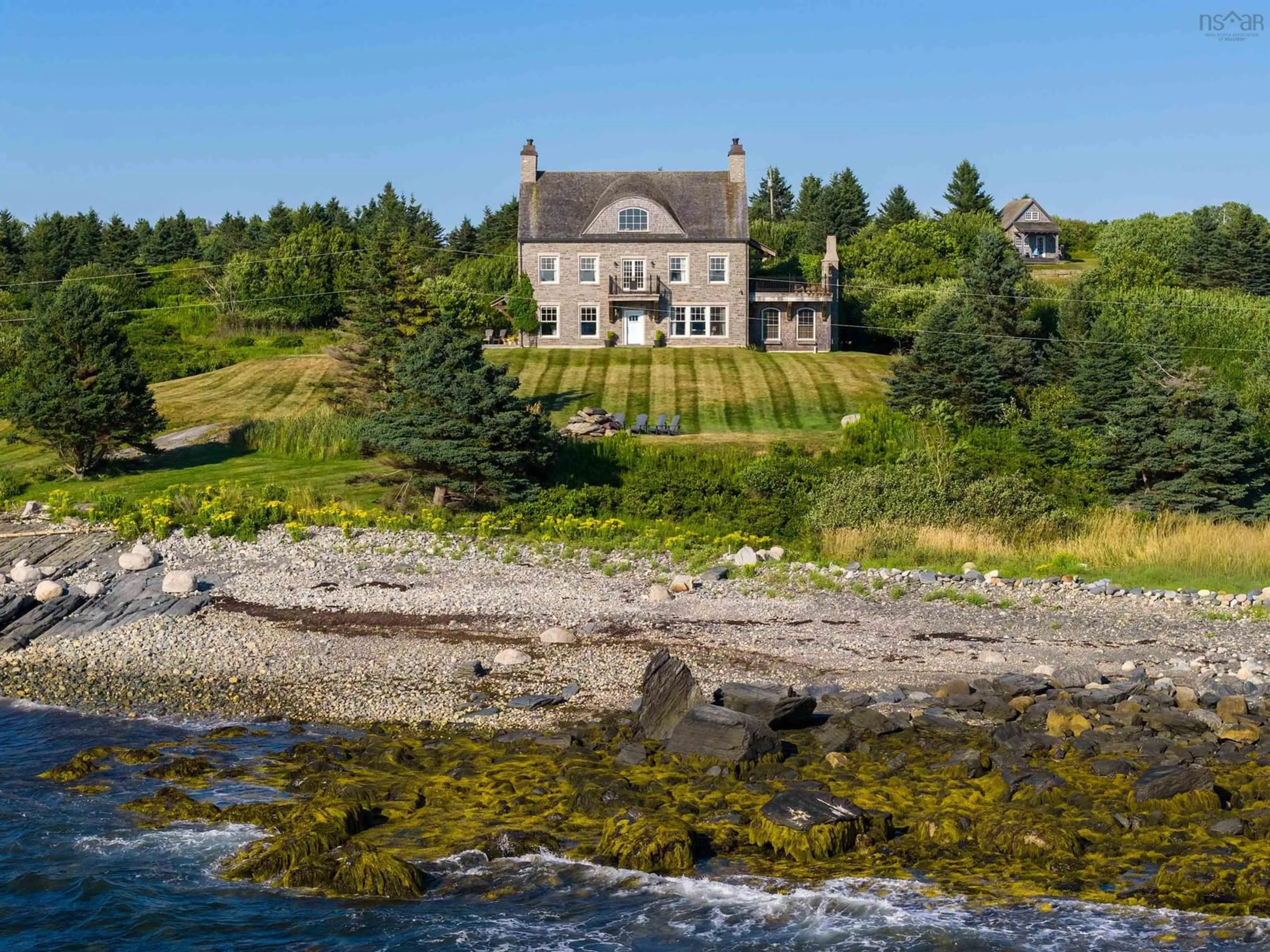A pic from outside/outdoor area/front of a property/back of a property/a pic from drone, water/lake/river/ocean view for 27 Seashore Lane, Blandford Nova Scotia B0J 1T0