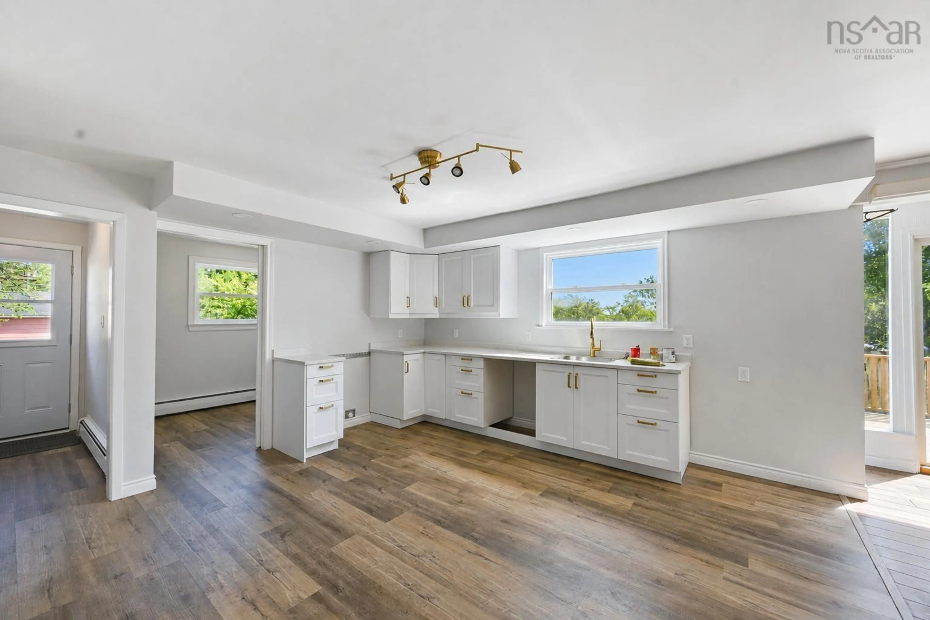 Open concept kitchen, wood/laminate floor for 21 Brown St, Sydney Mines Nova Scotia B1V 1E9